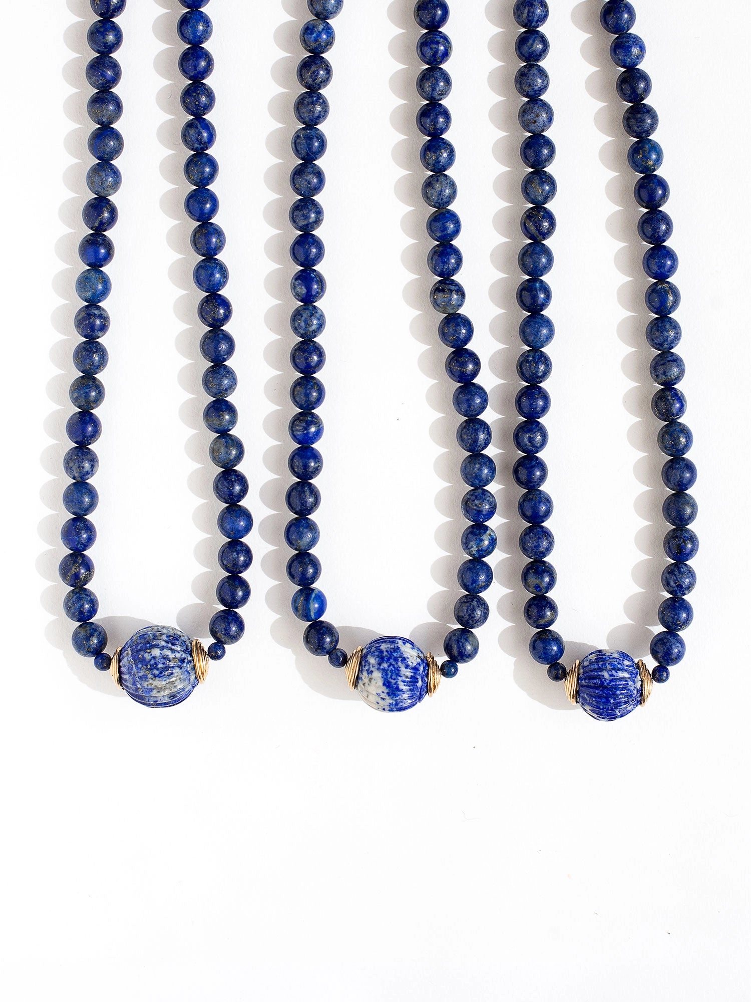 Three beaded lapis lazuli strand necklaces with large lapis lazuli and brass circular pendant by Canadian jewelry designer Michelle Ross