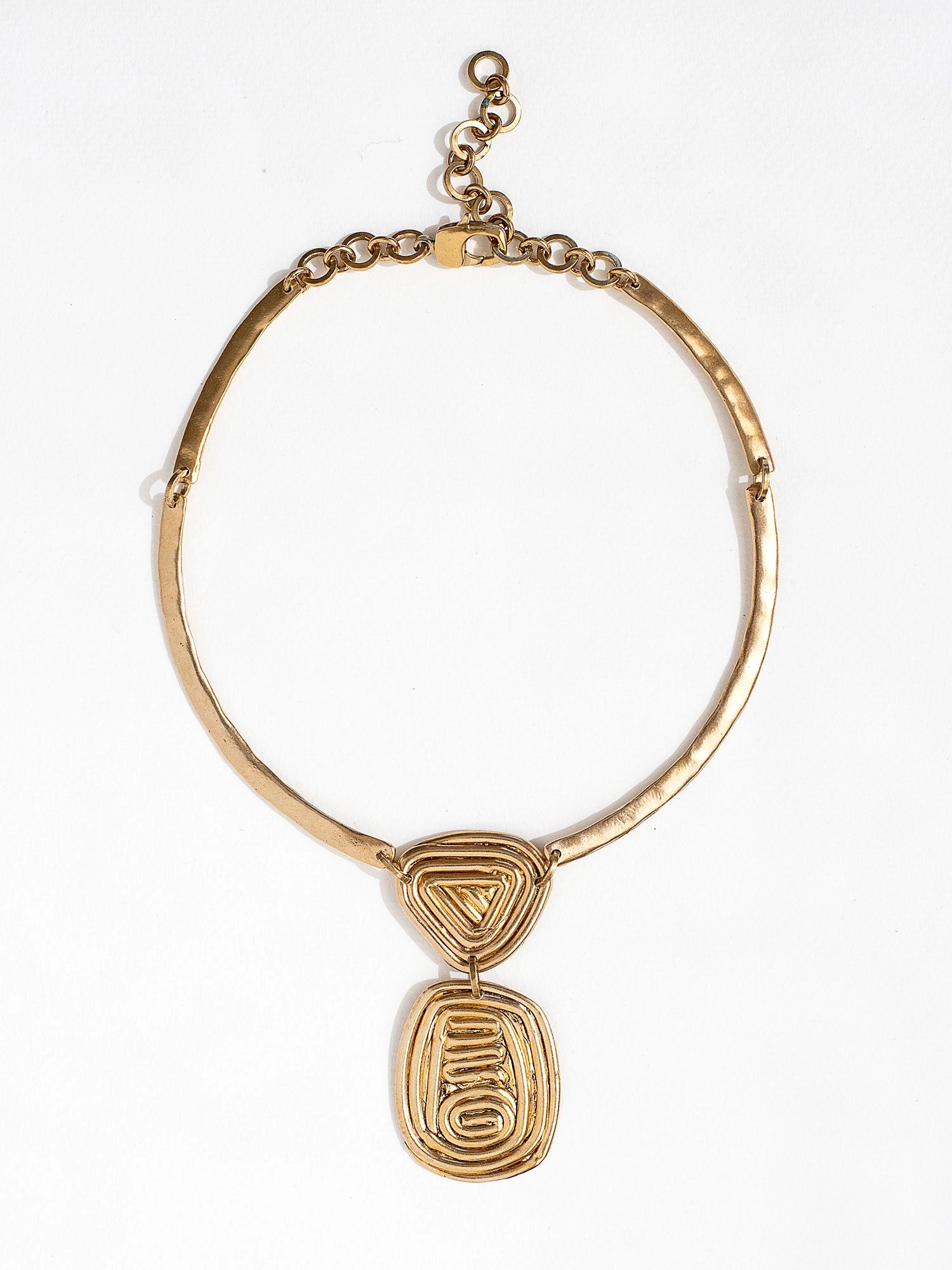 A solid brass collar necklace with a layered circular spiral pendants by Canadian jewelry designer Michelle Ross