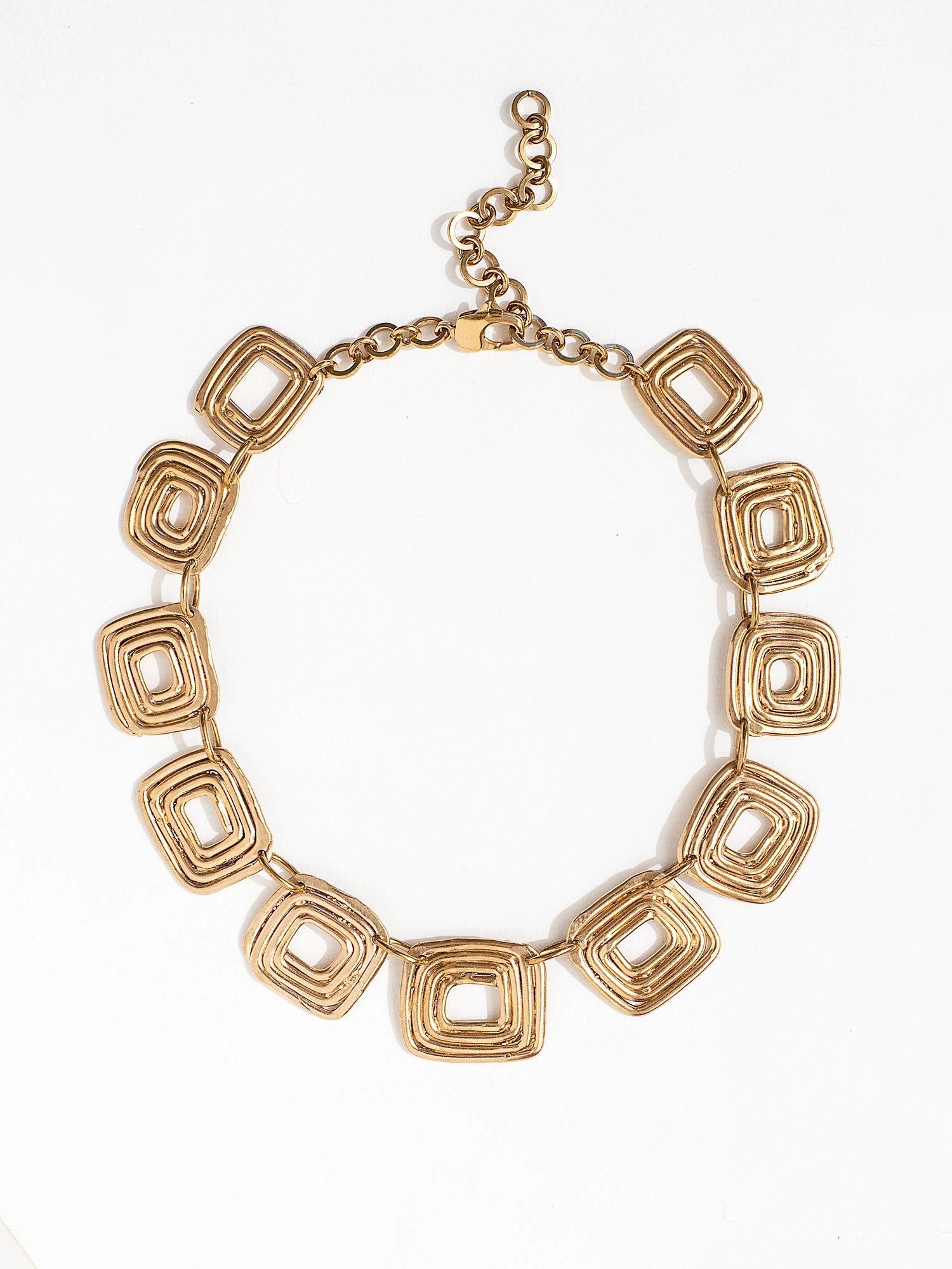 A statement necklace with brass spiral details by Canadian contemporary jewelry designer Michelle Ross