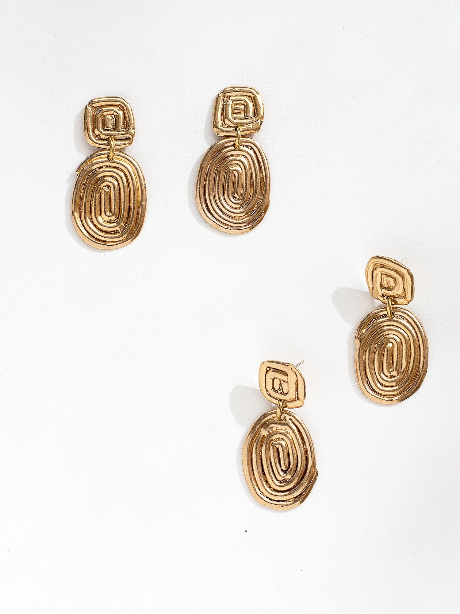 Two sets of brass spiral dangle drop earrings by Canadian jewellery designer Michelle Ross