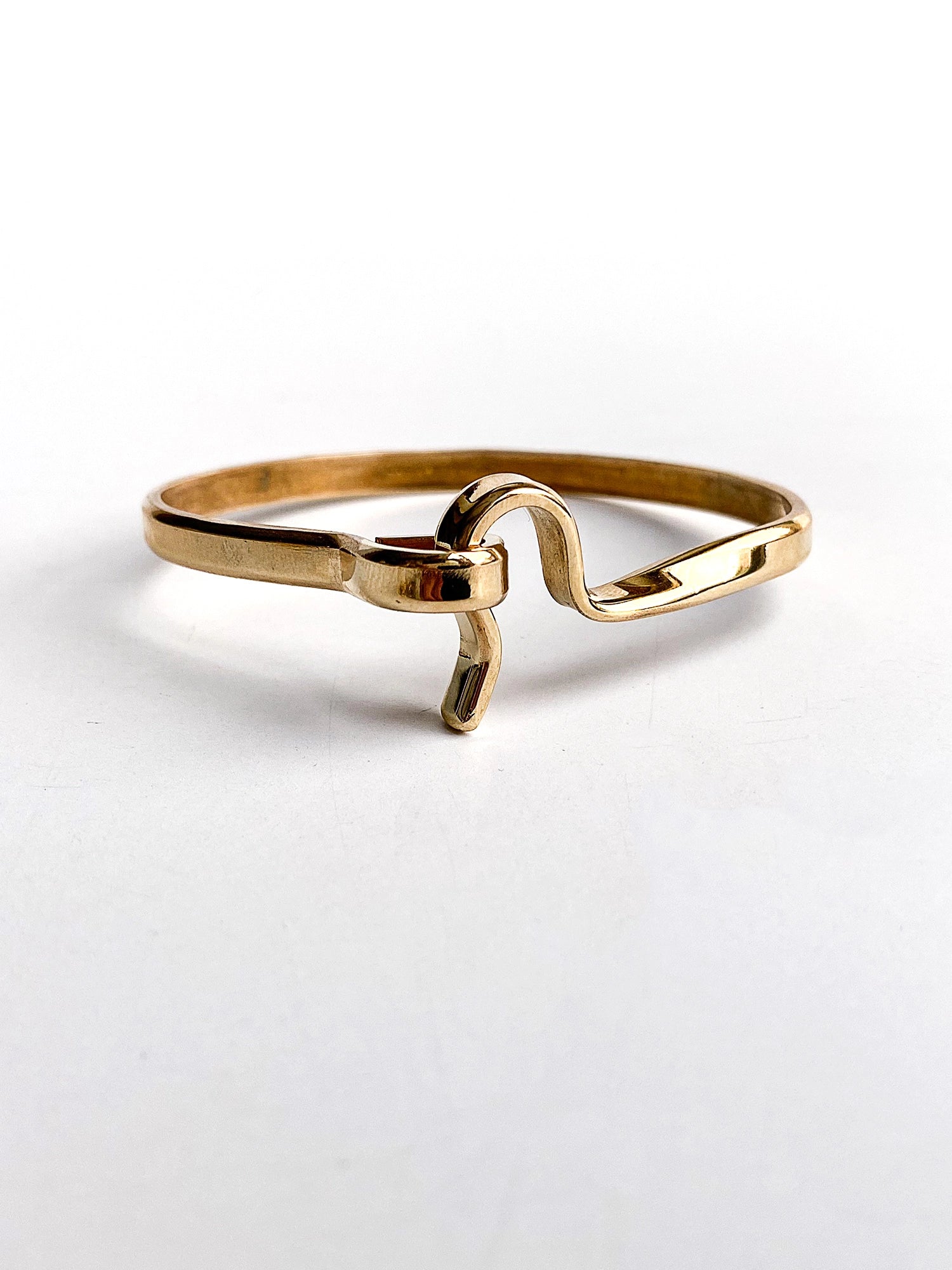 a smooth brass bangle bracelet handcrafted in Toronto by Michelle Ross