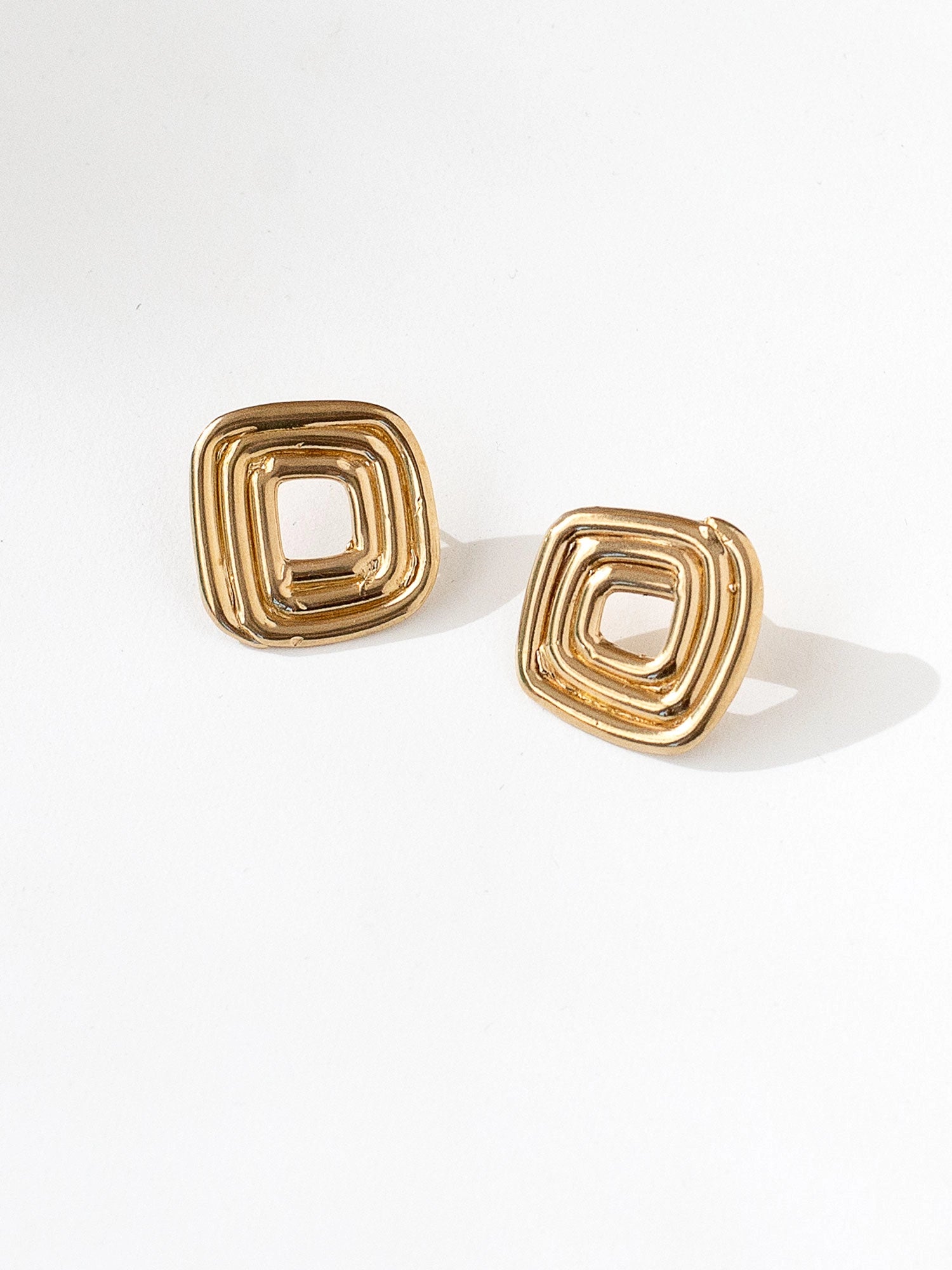 A set brass spiral stud earrings by Canadian jewellery designer Michelle Ross
