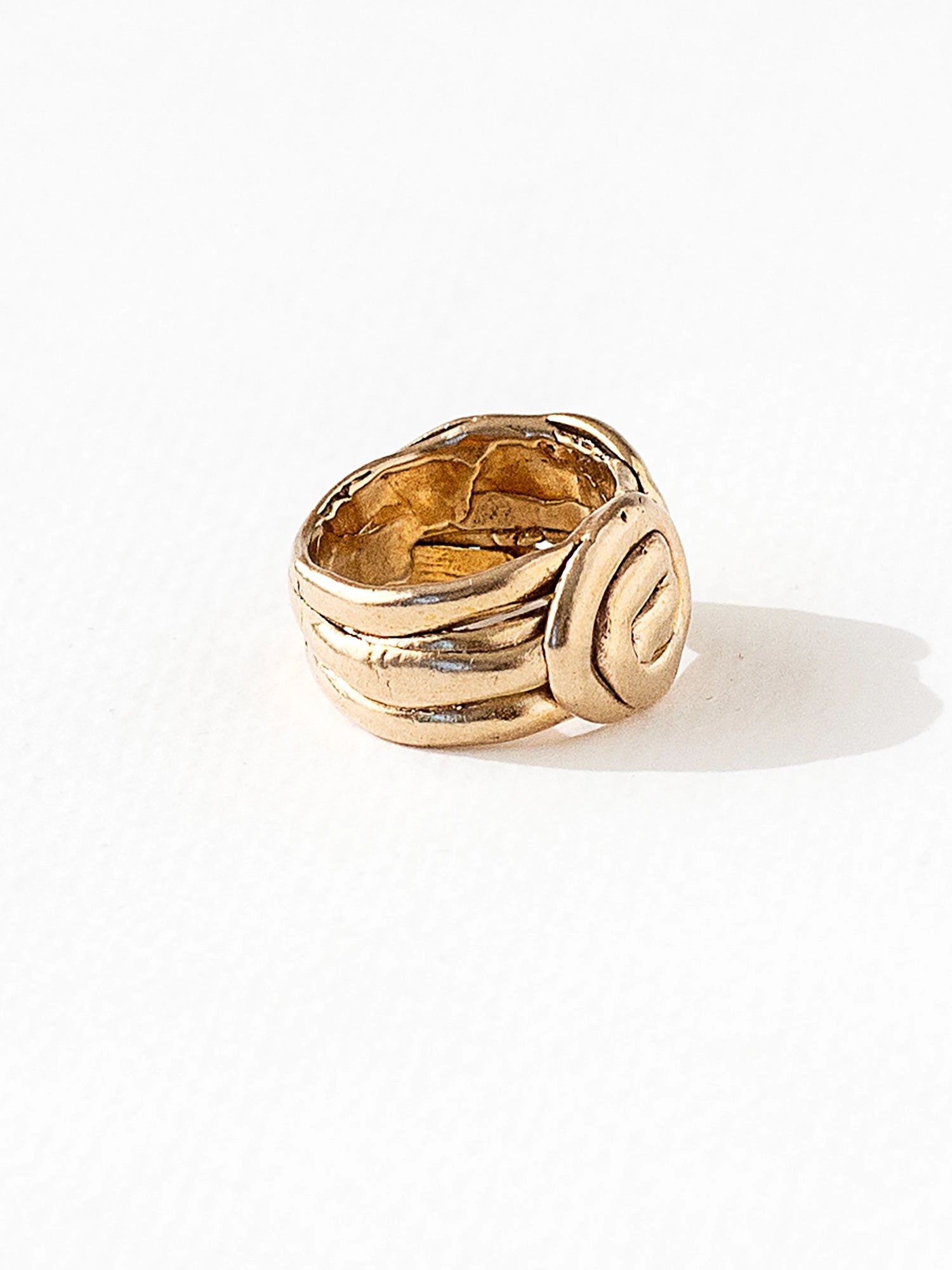 A hand formed brass ring with spiral geometric signet detail by Canadian jewelry designer Michelle Ross