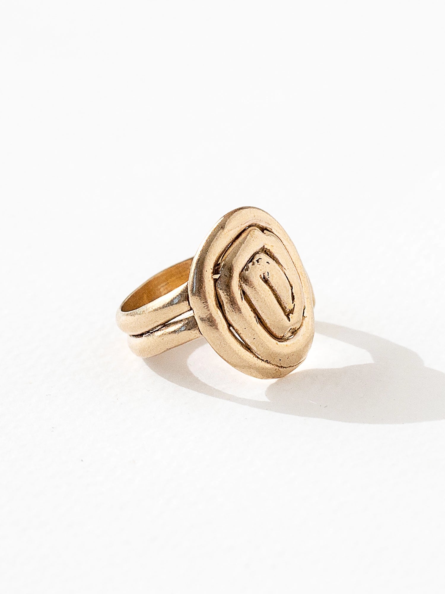 A hand formed brass ring with spiral geometric signet detail by Canadian jewelry designer Michelle Ross