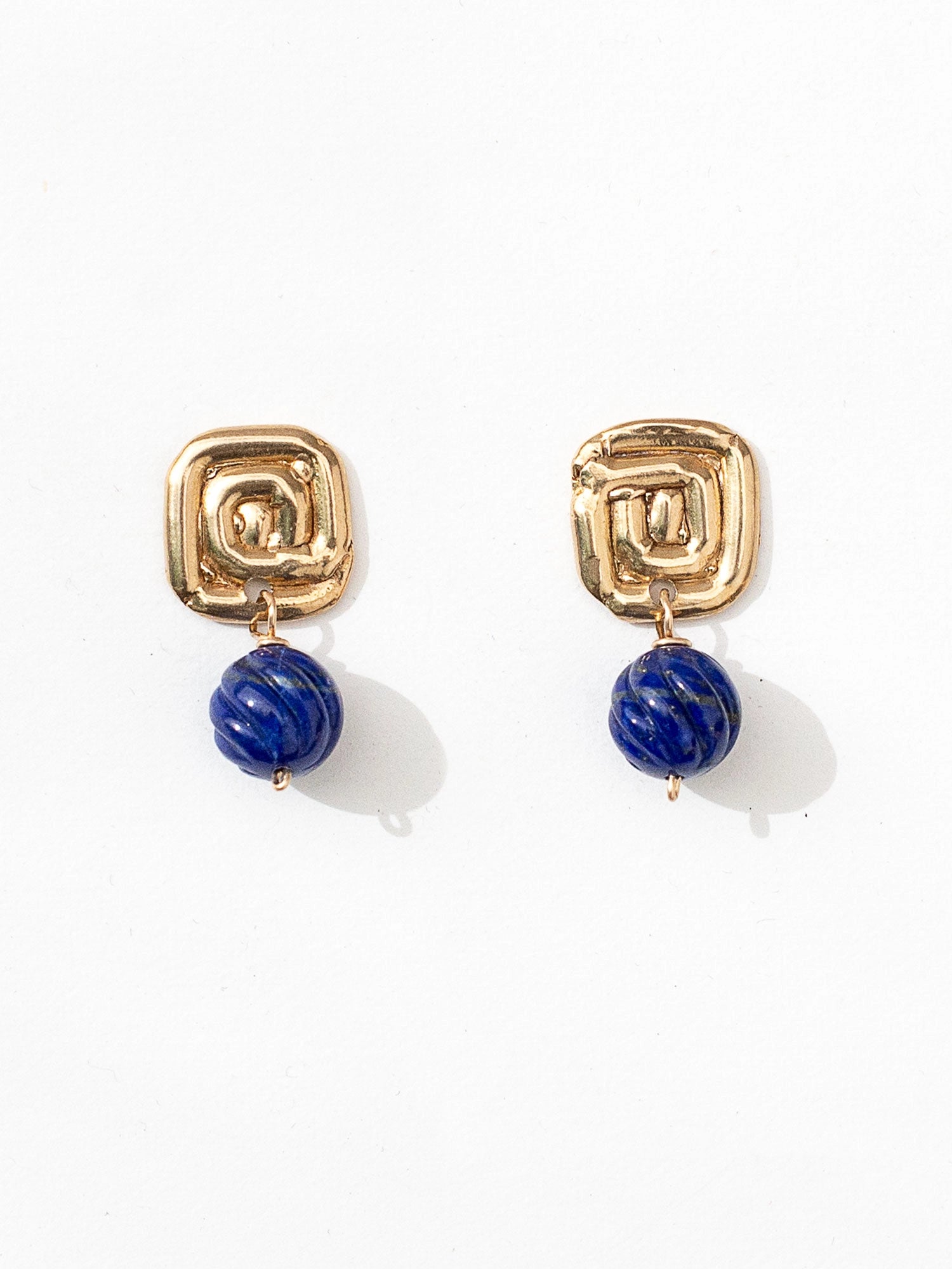 A pair of brass spiral and lapis lazuli drop earrings by contemporary designer Michelle Ross