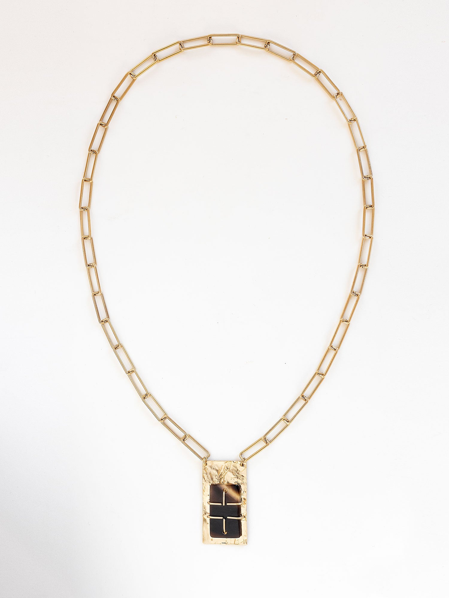 A brass rectangular chain link necklace with statement brass and horn rectangular pendant by Michelle Ross