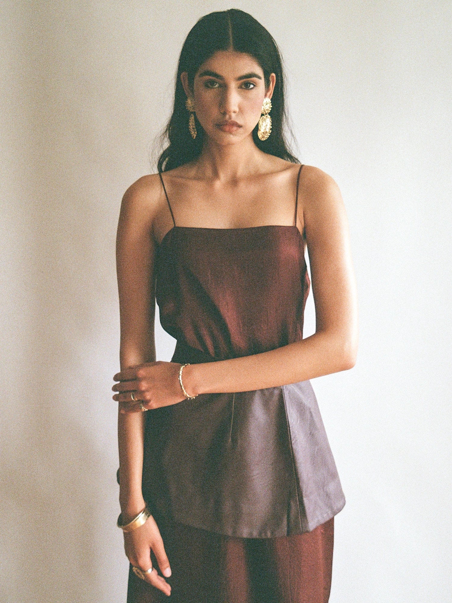 Woman wears Nisa Handmade Large Brass Statement Earrings by Michelle Ross