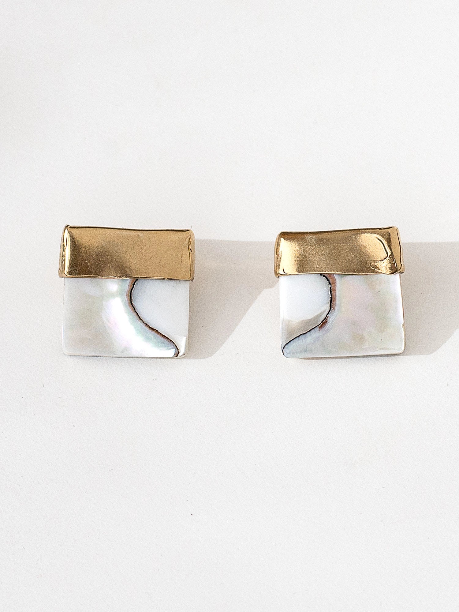 A pair of square shell mother of pearl and brass statement earrings by contemporary designer Michelle Ross