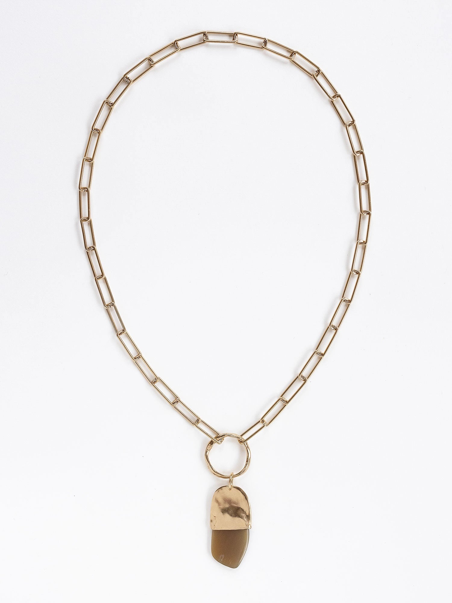A brass chain necklace with a camel horn pendant by Michelle Ross