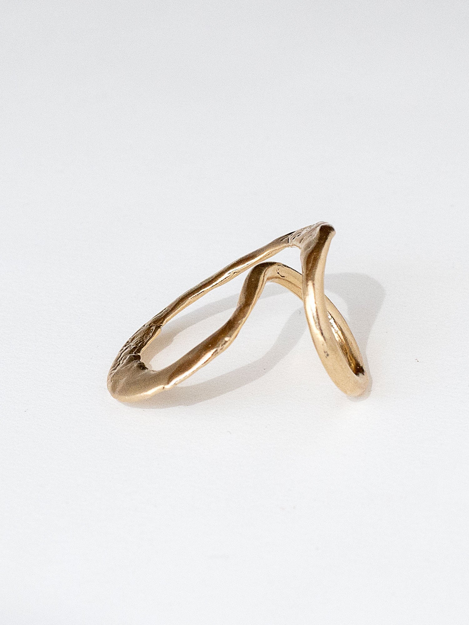 A handmade solid brass ring in an artistic twisting shape by Michele Ross in Toronto, Canada