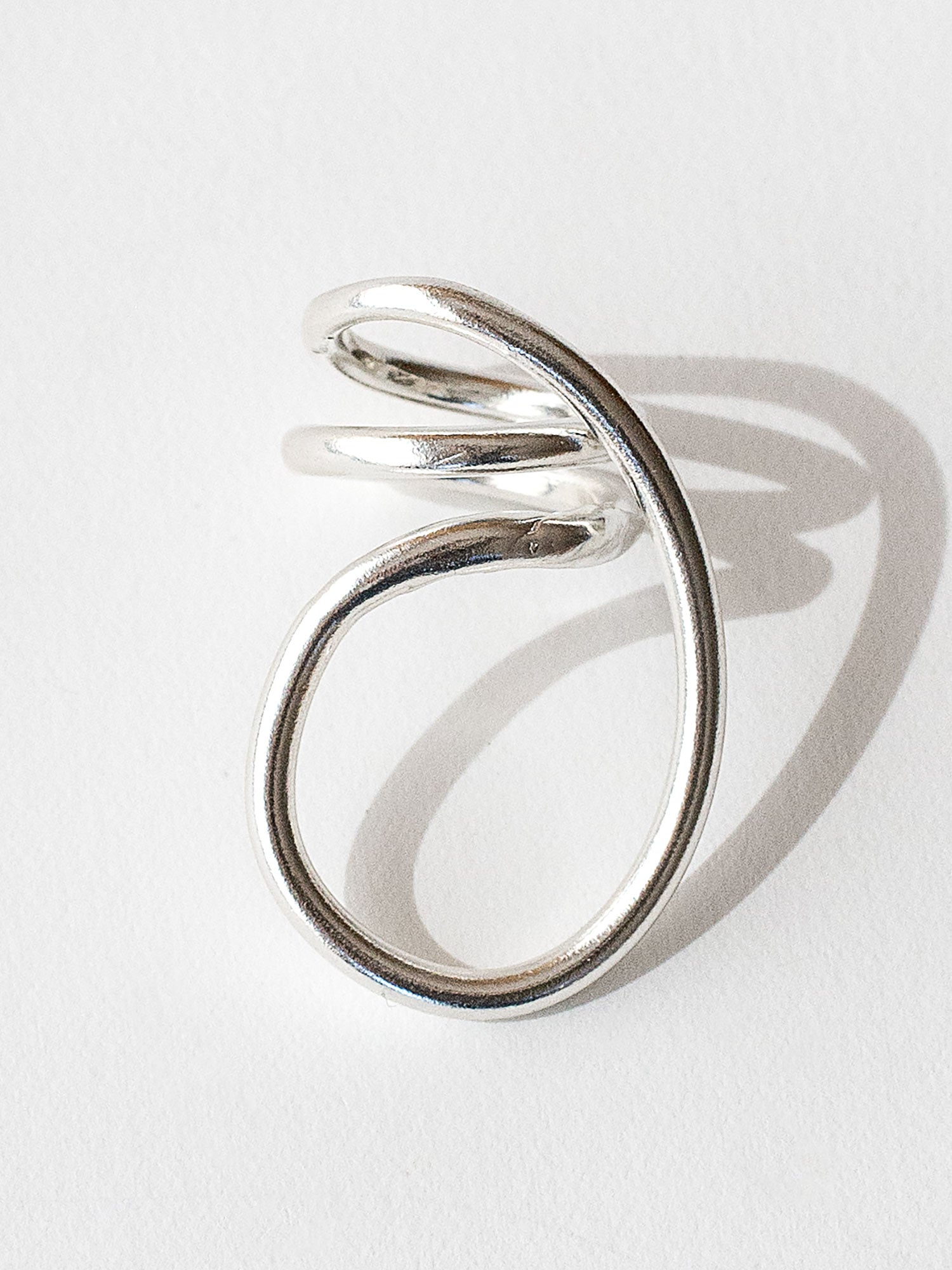 A handmade solid sterling silver ring in an artistic twisting shape by Michele Ross in Toronto, Canada