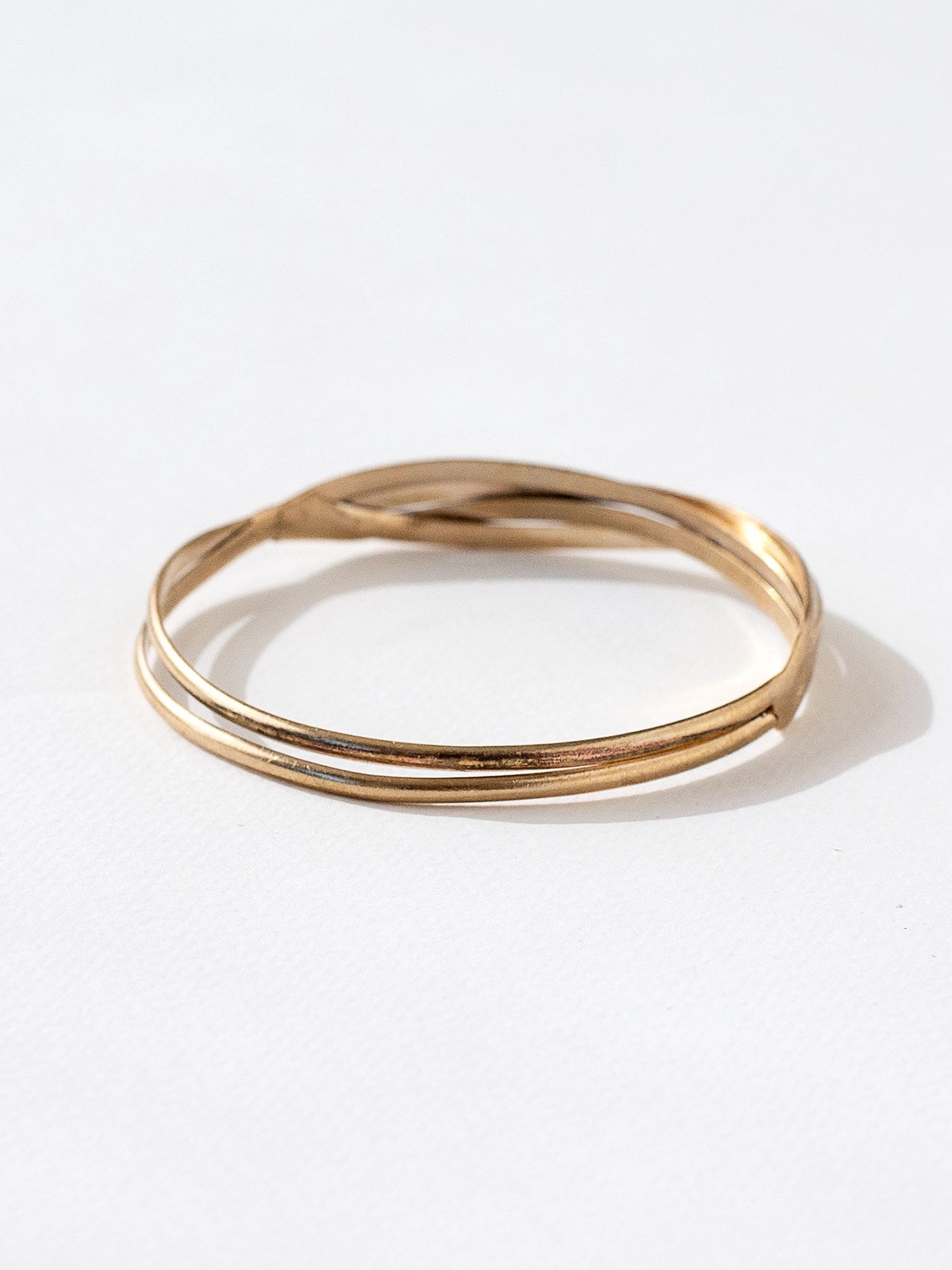 A solid brass stacked bangle bracelet by contemporary jewelry designer Michelle Ross