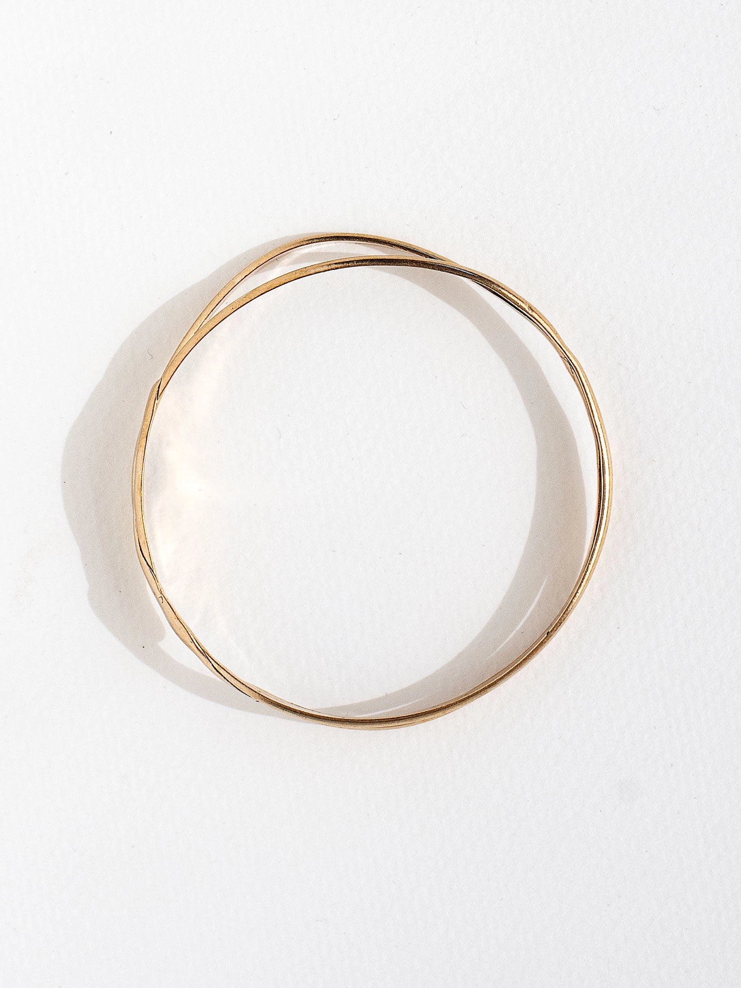 A solid brass stacked bangle bracelet by contemporary jewelry designer Michelle Ross