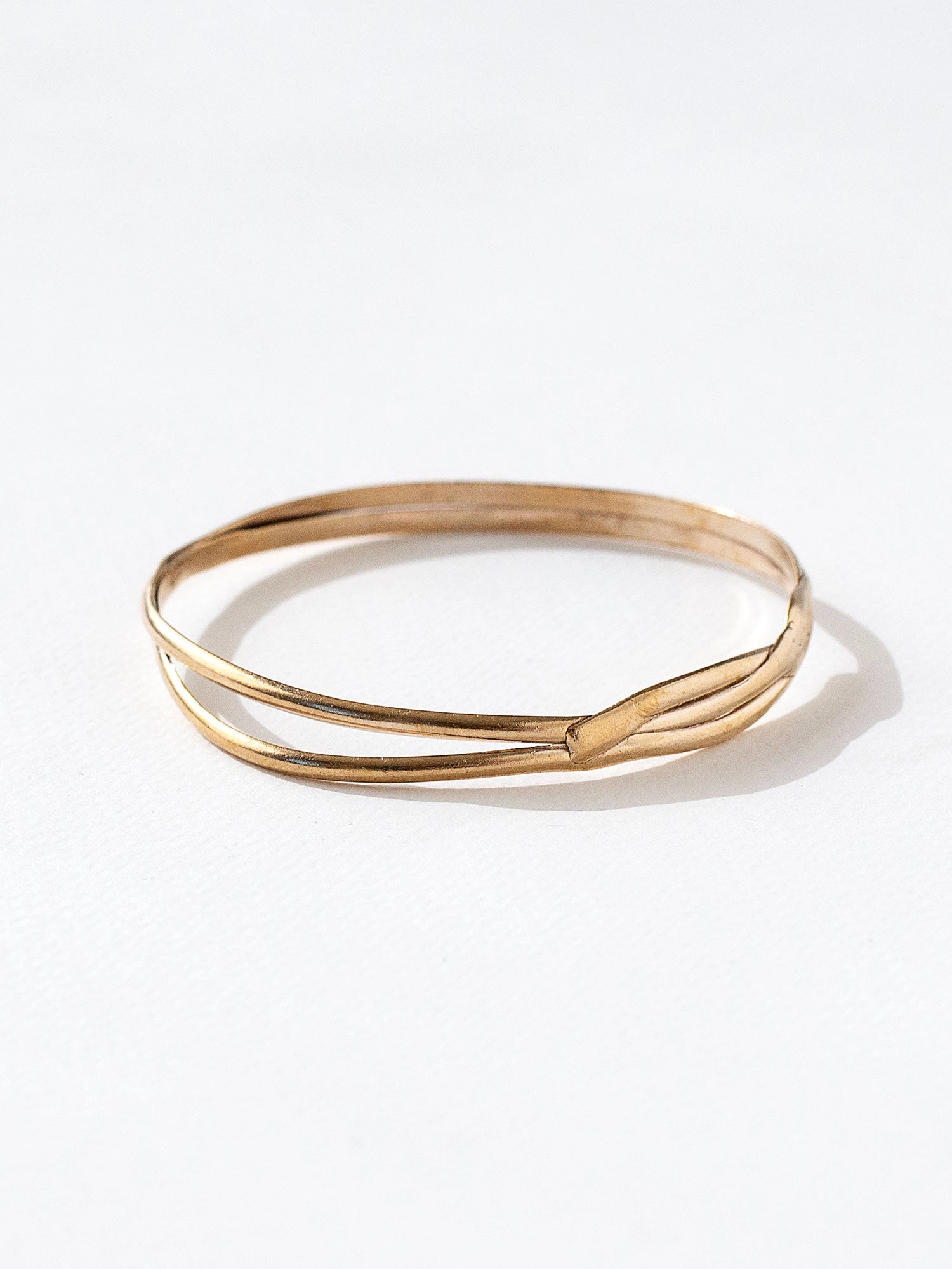 A solid brass stacked bangle bracelet by contemporary jewelry designer Michelle Ross