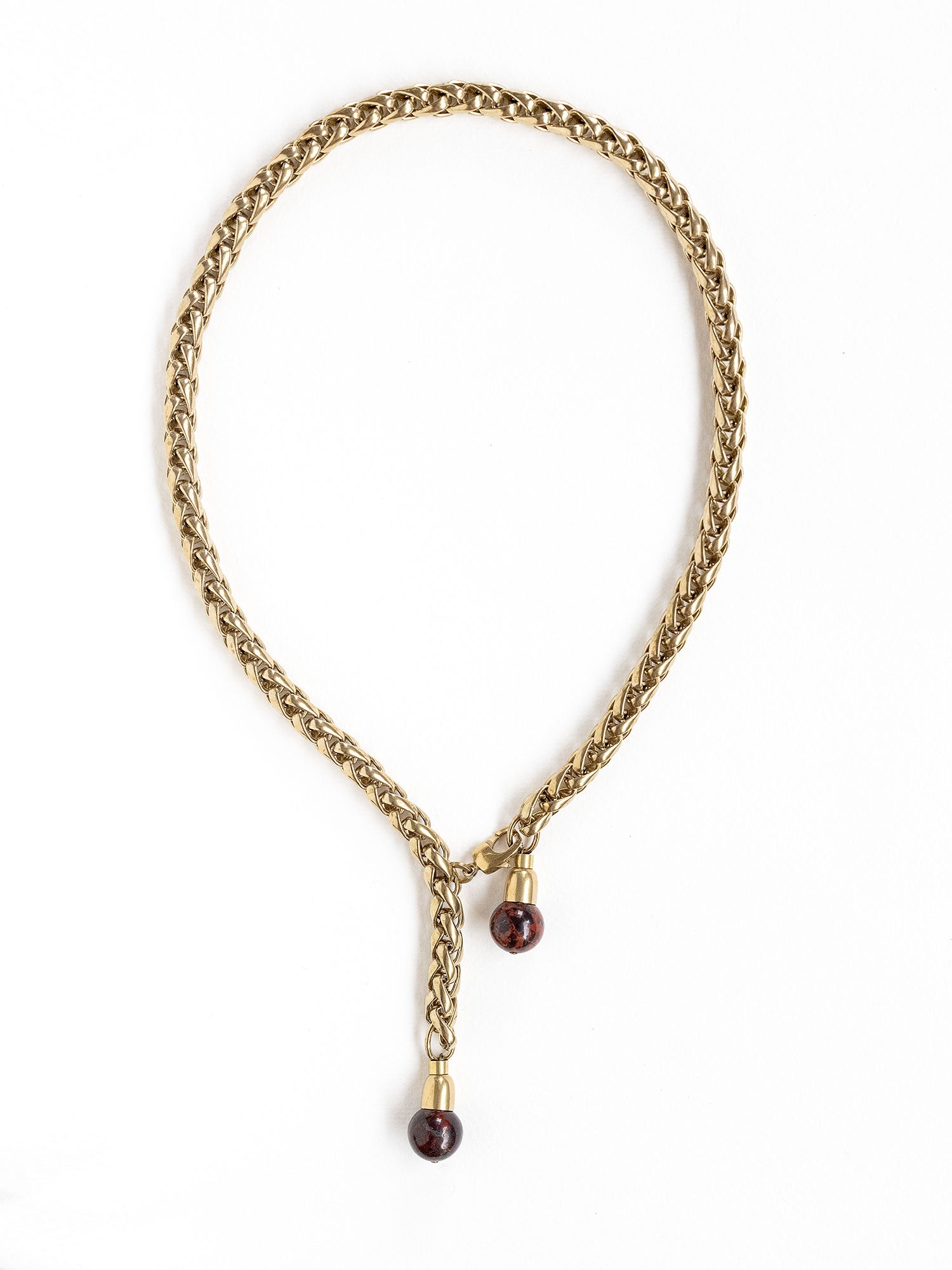 A brass chain lariat necklace with two red jasper bead tassels by Canadian jewelry designer Michelle Ross