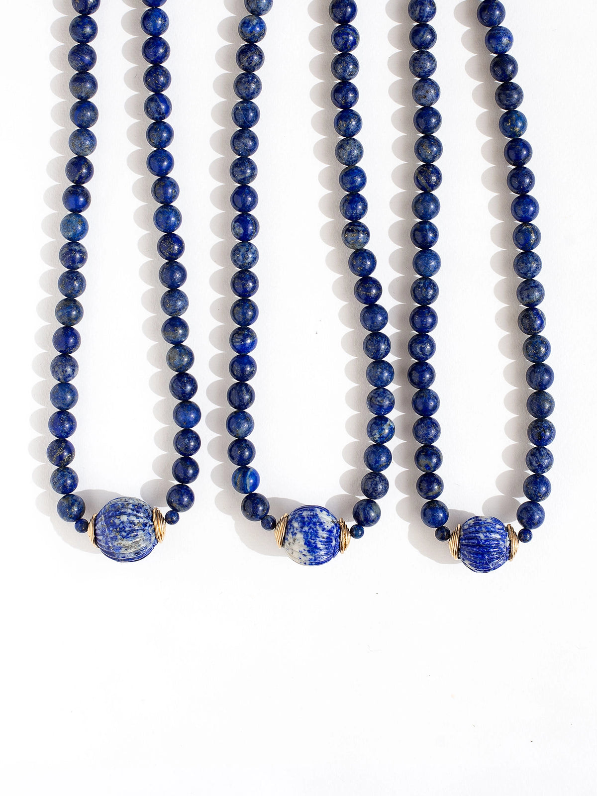 Three beaded lapis lazuli strand necklaces with large lapis lazuli and brass circular pendant by Canadian jewelry designer Michelle Ross