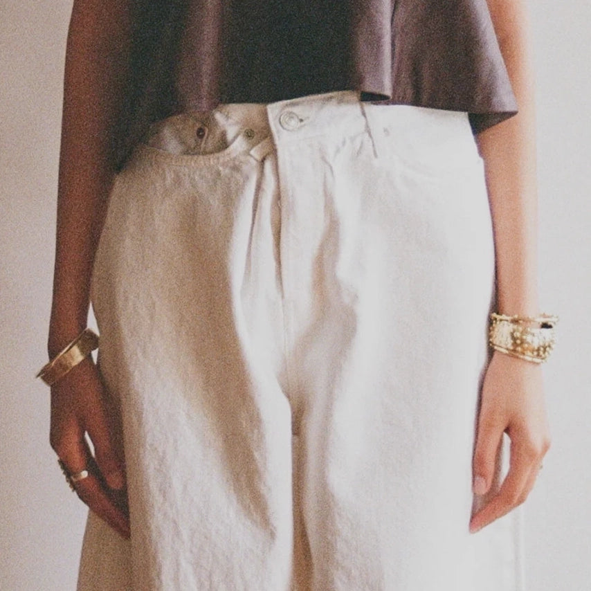 A woman wears brass cuffs and bangle bracelets handmade by Canadian jewellery designer Michelle Ross from Toronto