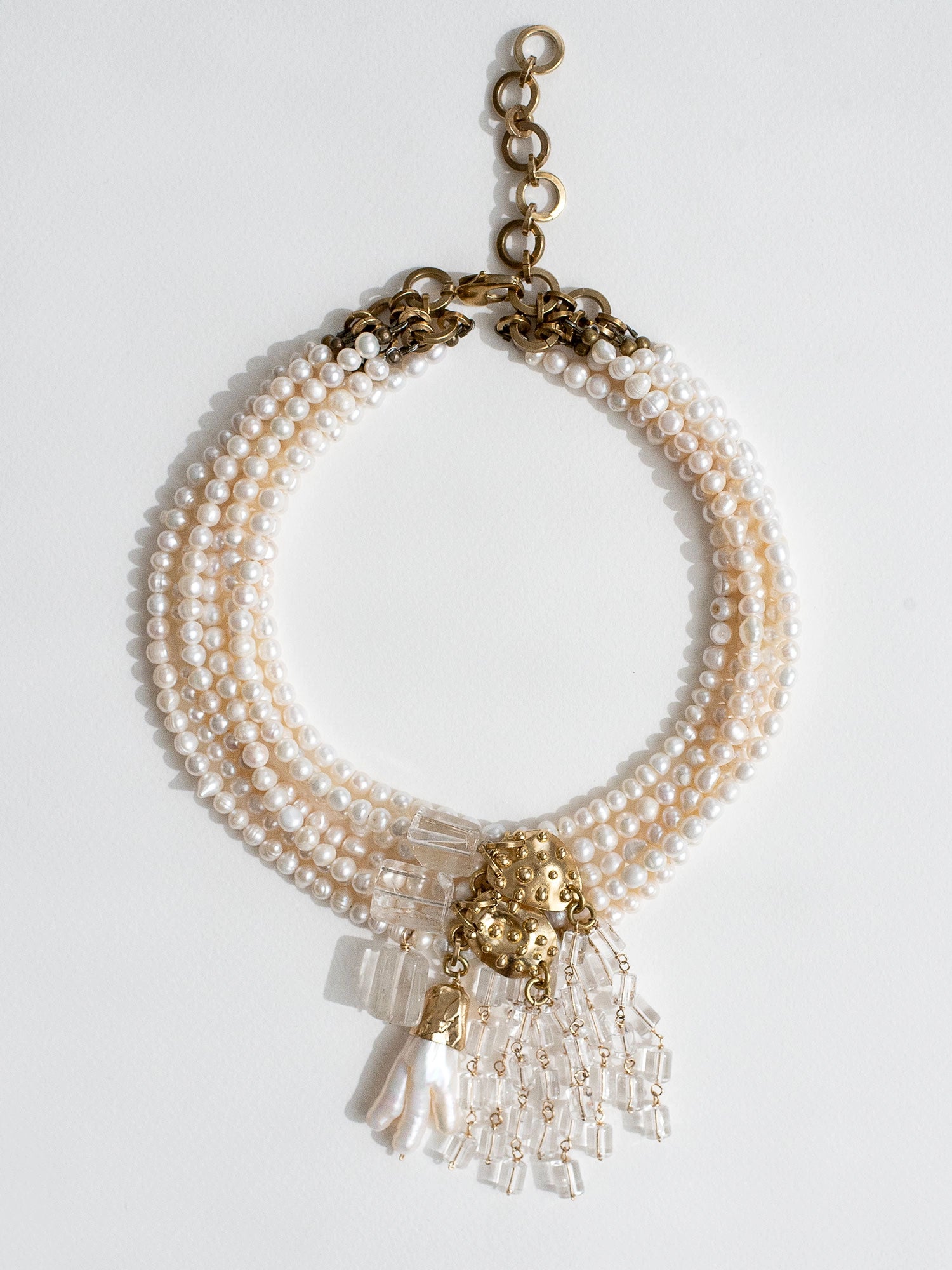 A contemporary pearl multistrand freshwater pearl statement necklace with crystal quartz and brass