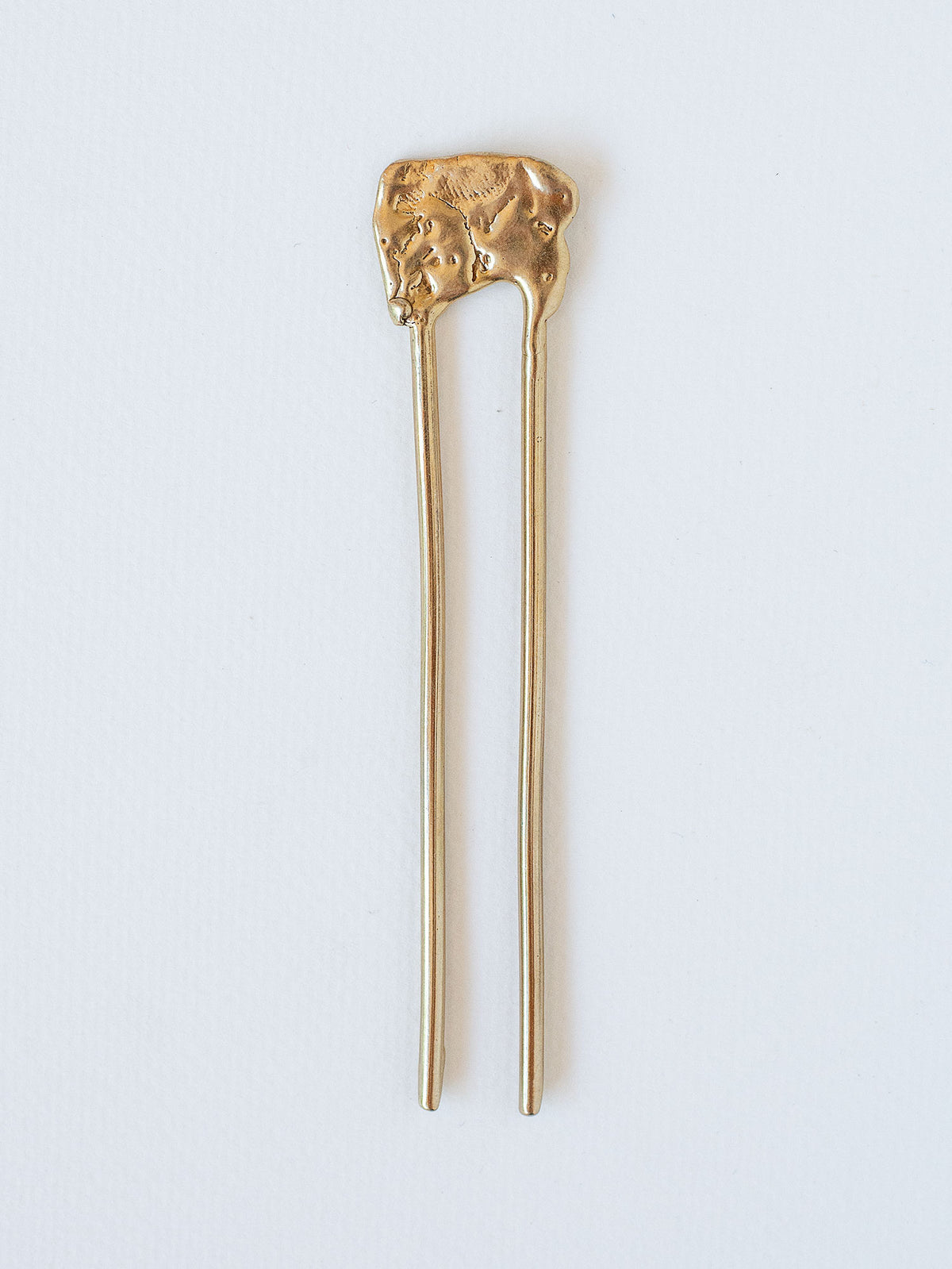Gold hairpin with decorative top by Michelle Ross