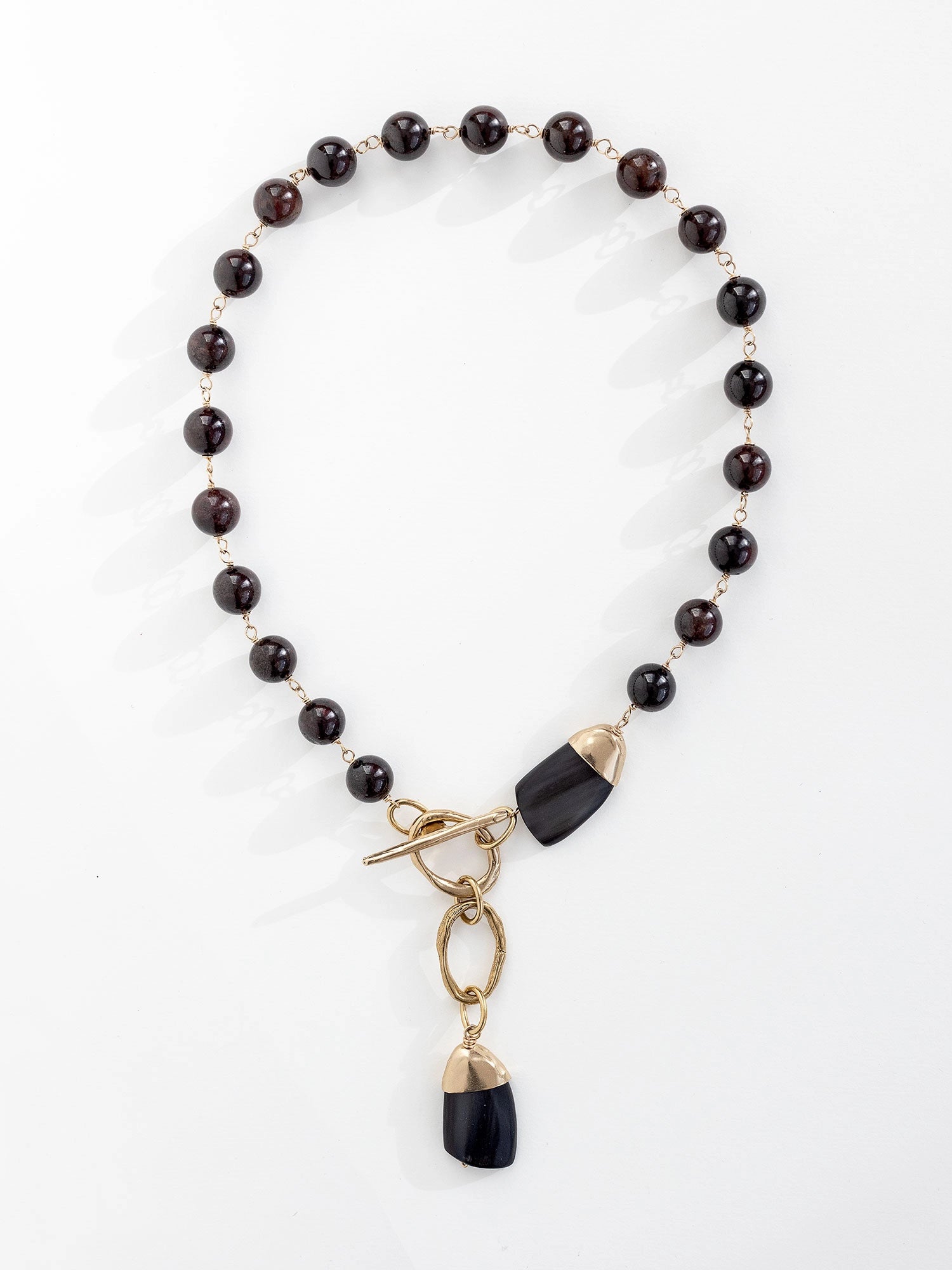 Lariat necklace with garnet beads and brass accents by Michelle Ross
