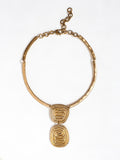 A solid brass collar necklace with a layered circular spiral pendants by Canadian jewelry designer Michelle Ross