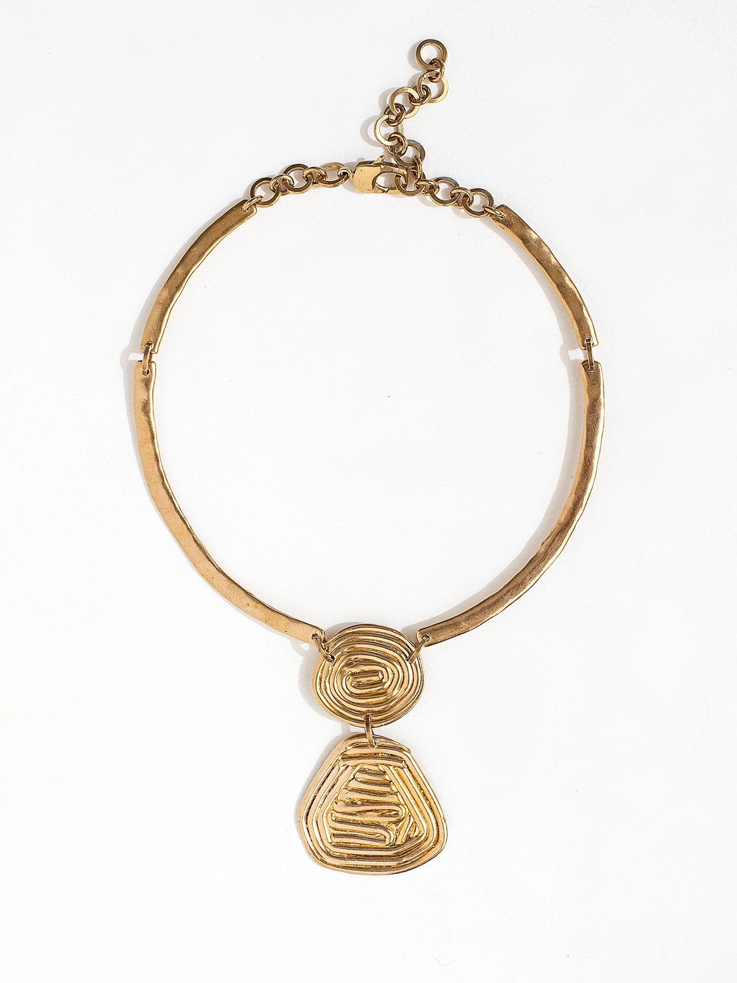A solid brass collar necklace with a layered circular spiral pendants by Canadian jewelry designer Michelle Ross