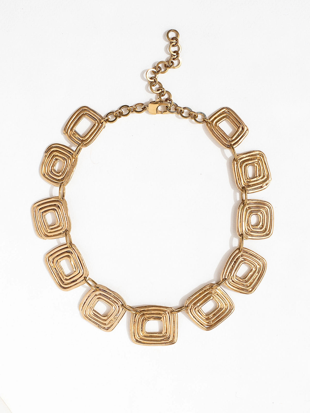 A statement necklace with brass spiral details by Canadian contemporary jewelry designer Michelle Ross