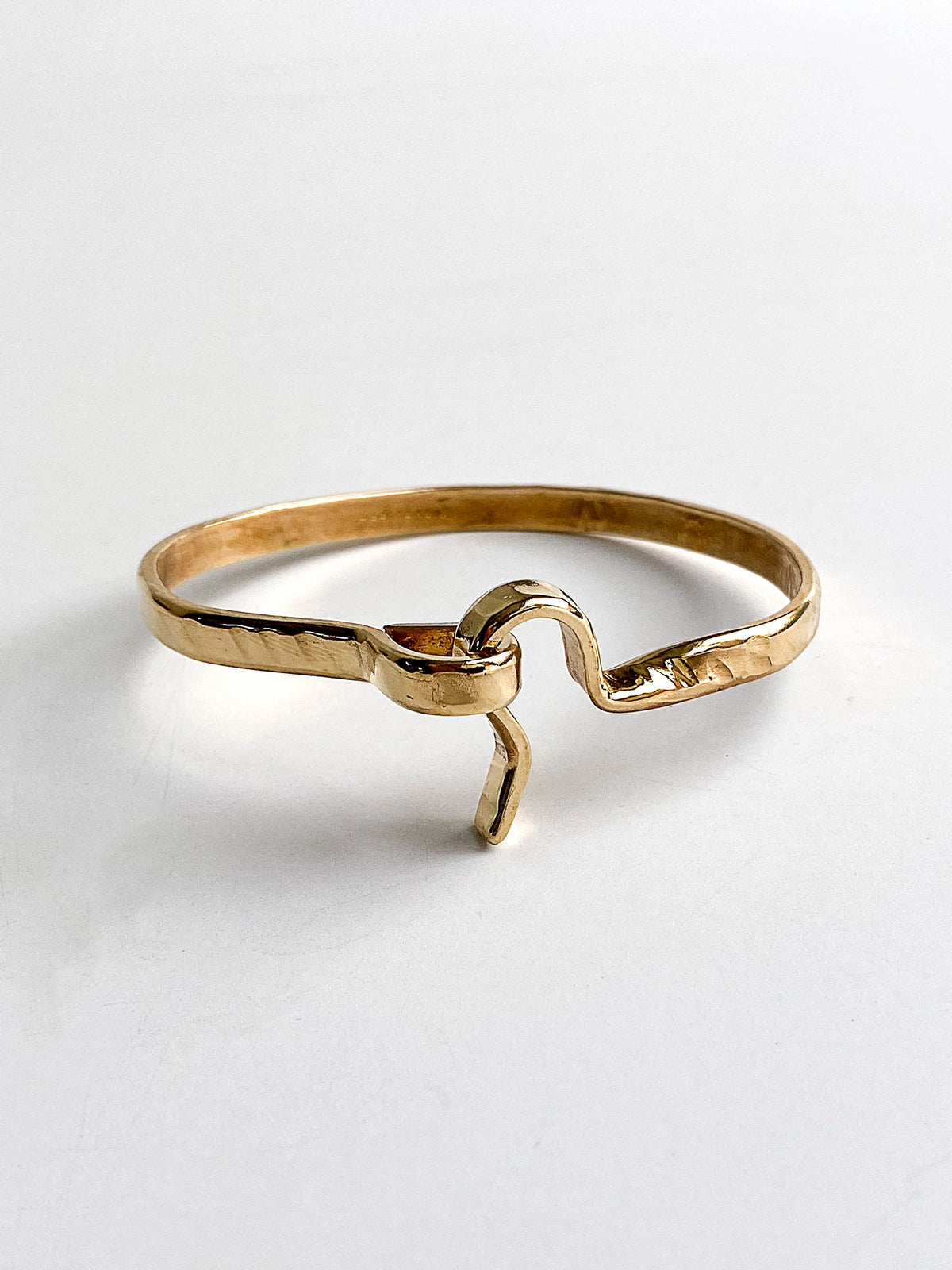 a hammered brass bangle bracelet handcrafted in Toronto by Michelle Ross