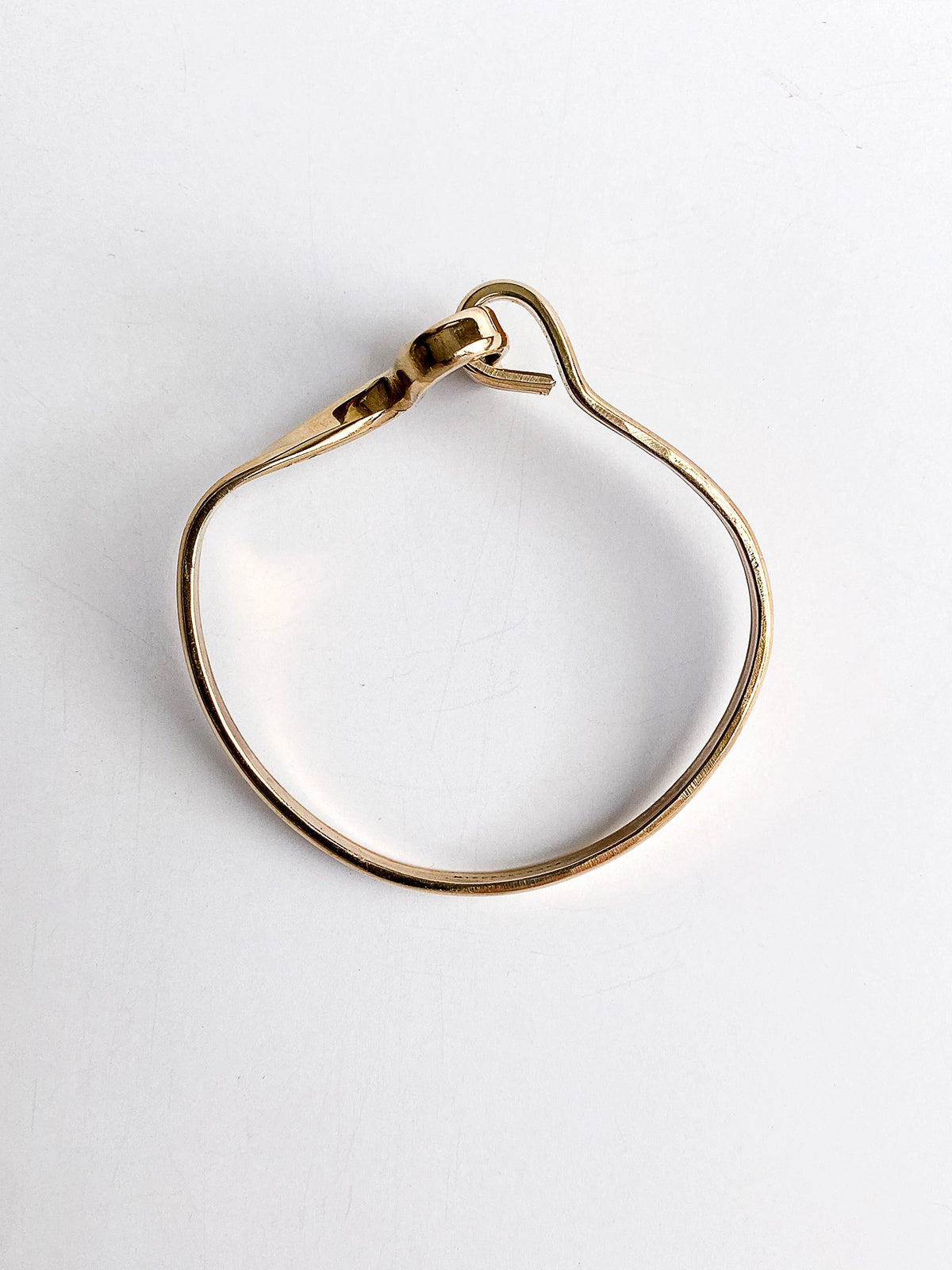 a smooth brass bangle bracelet handcrafted in Toronto by Michelle Ross