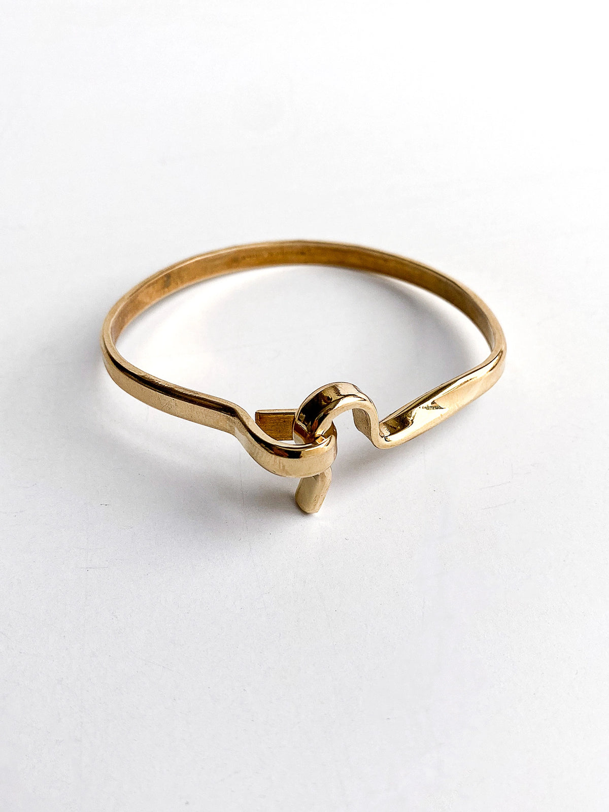 a smooth brass bangle bracelet handcrafted in Toronto by Michelle Ross