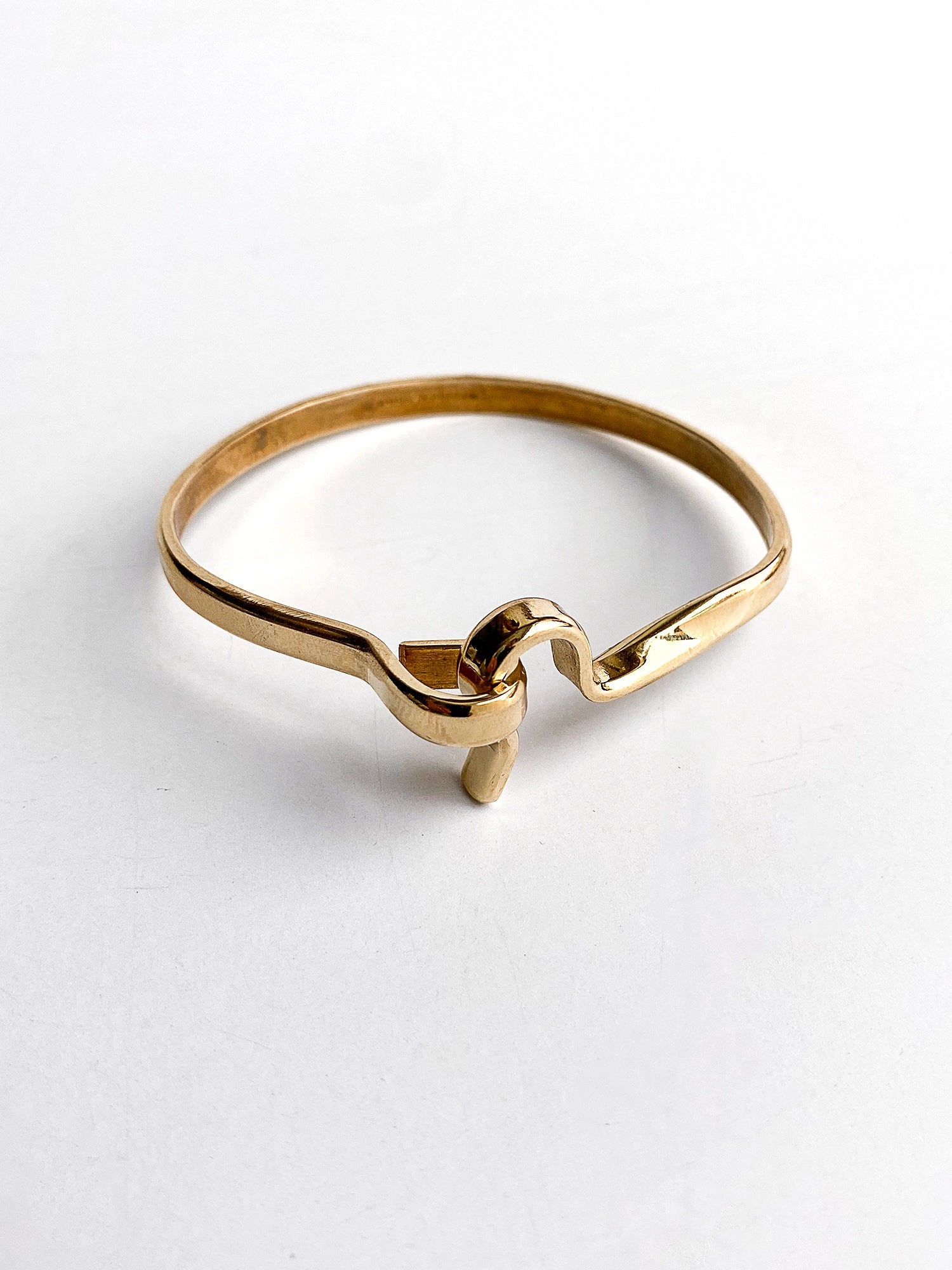 a smooth brass bangle bracelet handcrafted in Toronto by Michelle Ross