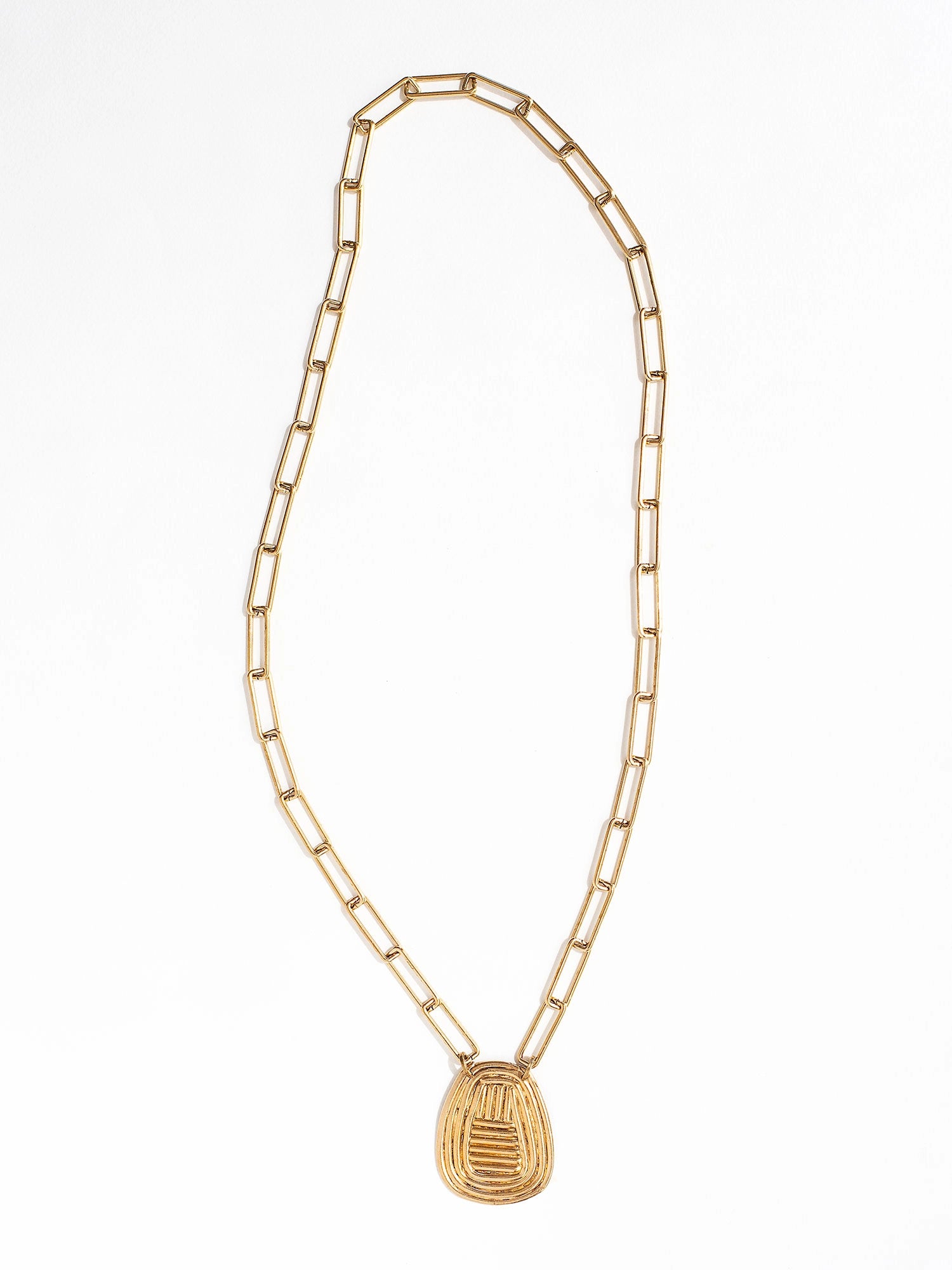 A brass chain link necklace with spiral circular pendant handcrafted by Canadian jewelry designer Michelle Ross