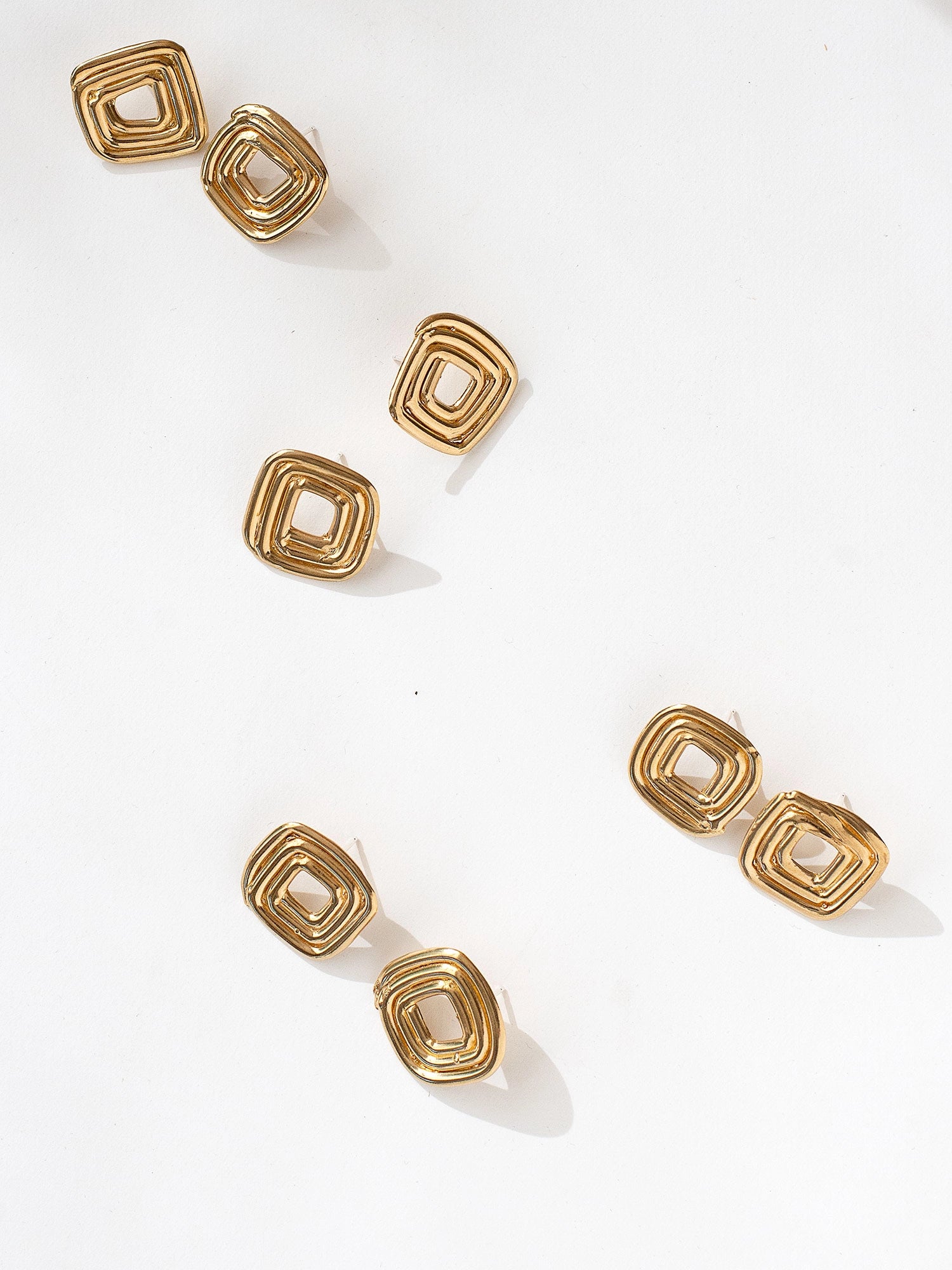 Four sets of brass spiral stud earrings by Canadian jewellery designer Michelle Ross 