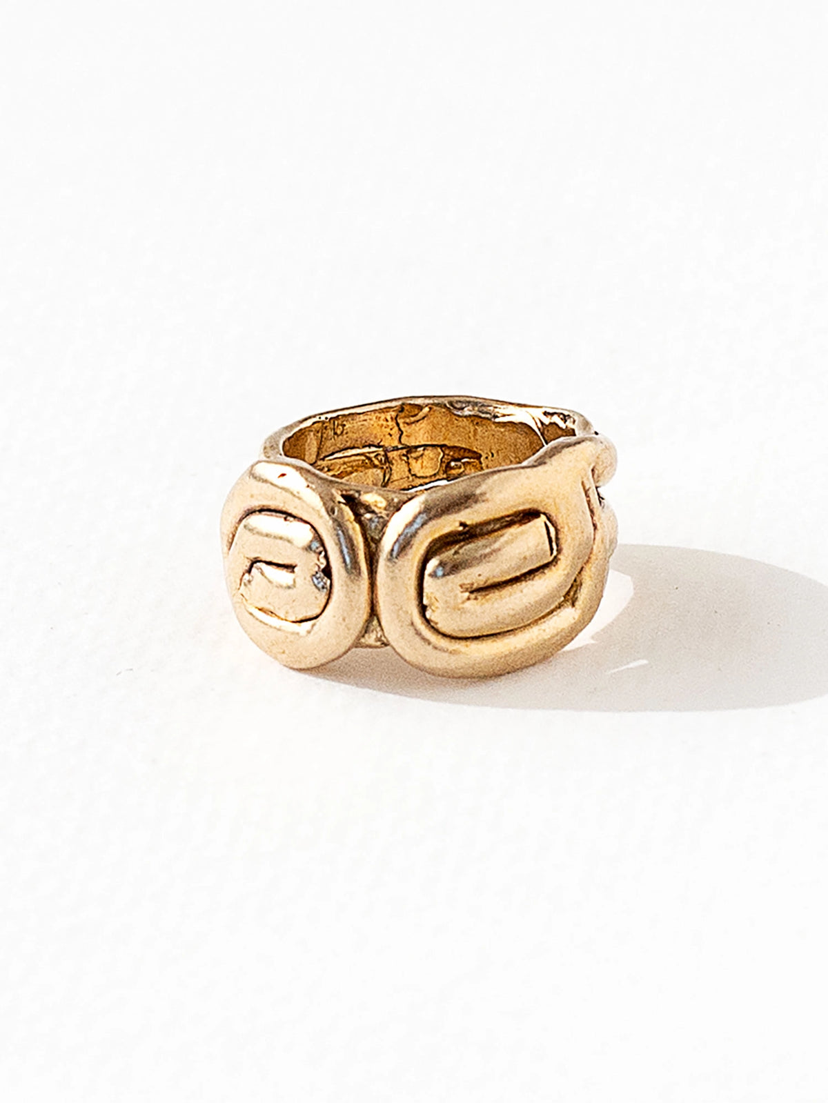A hand formed brass ring with spiral geometric signet detail by Canadian jewelry designer Michelle Ross