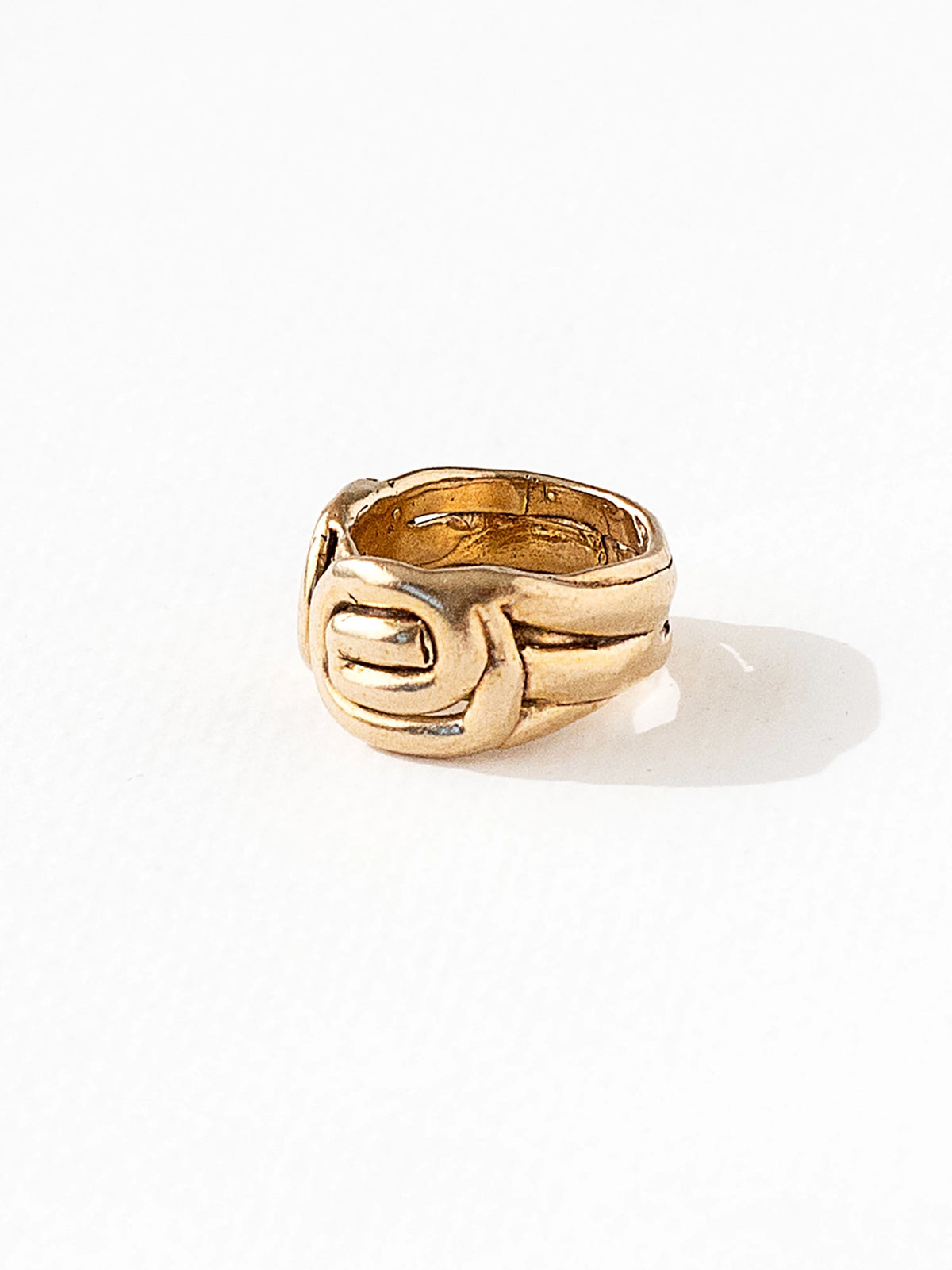 A hand formed brass ring with spiral geometric signet detail by Canadian jewelry designer Michelle Ross