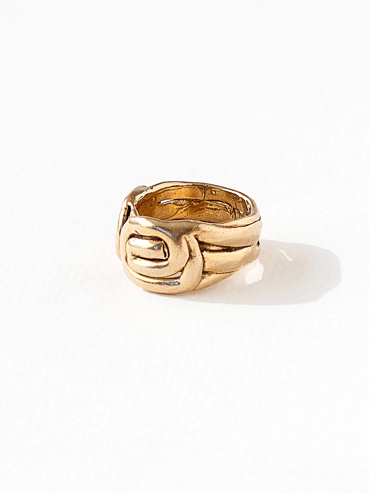 A hand formed brass ring with spiral geometric signet detail by Canadian jewelry designer Michelle Ross