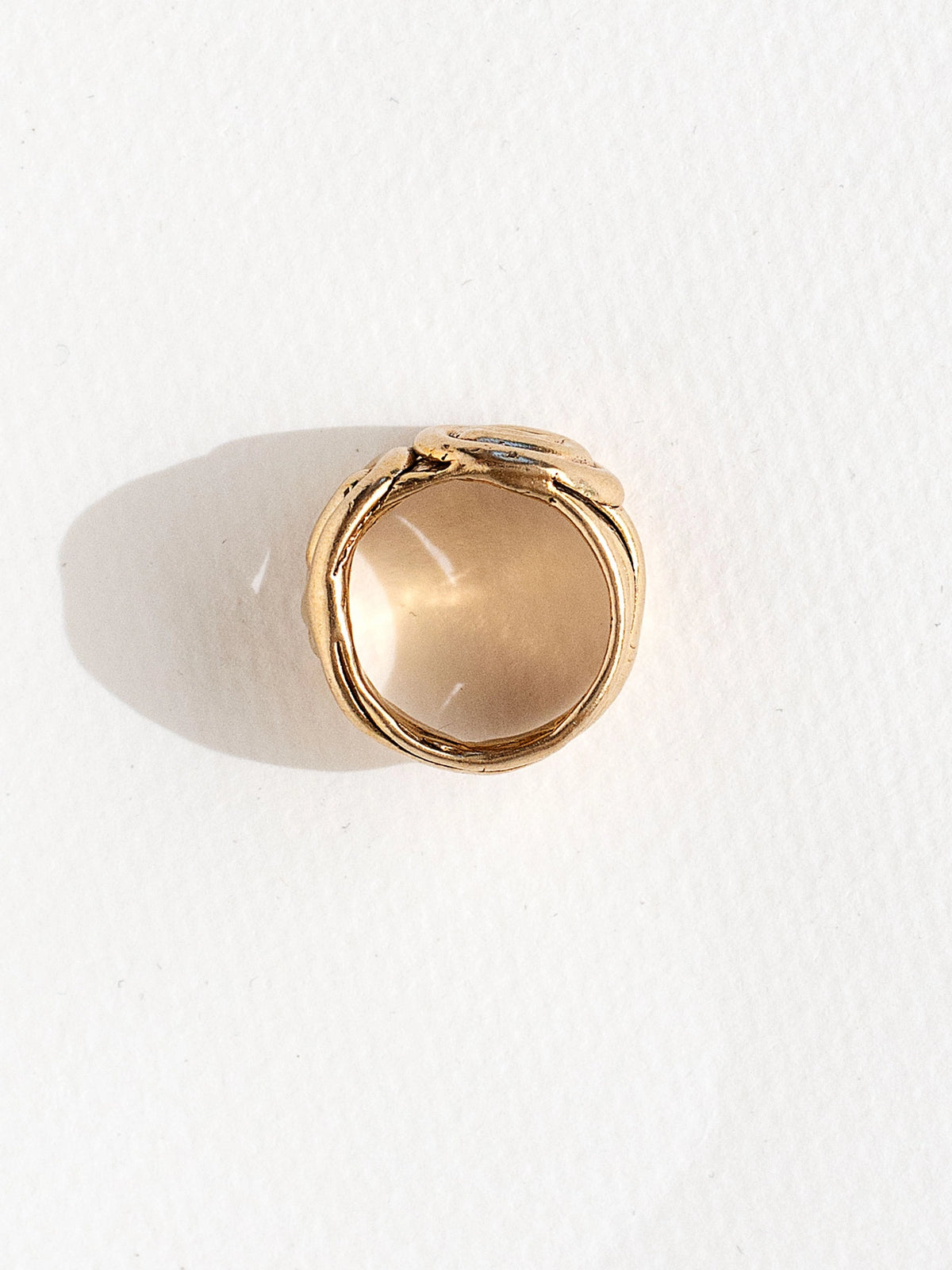 A hand formed brass ring with spiral geometric signet detail by Canadian jewelry designer Michelle Ross
