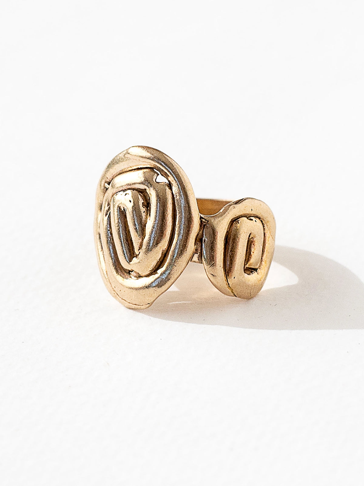 A hand formed brass ring with spiral geometric signet detail by Canadian jewelry designer Michelle Ross