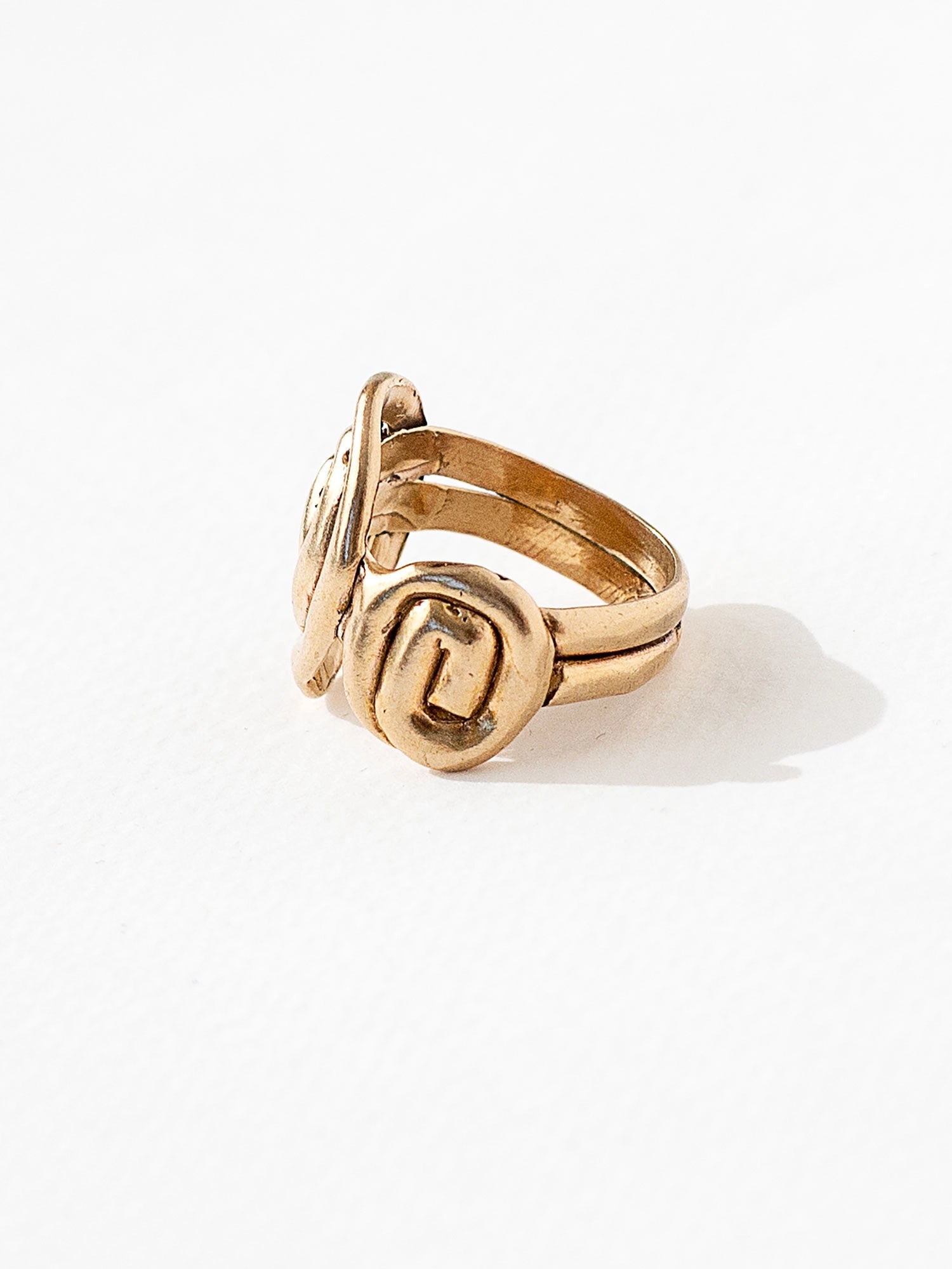 A hand formed brass ring with spiral geometric signet detail by Canadian jewelry designer Michelle Ross