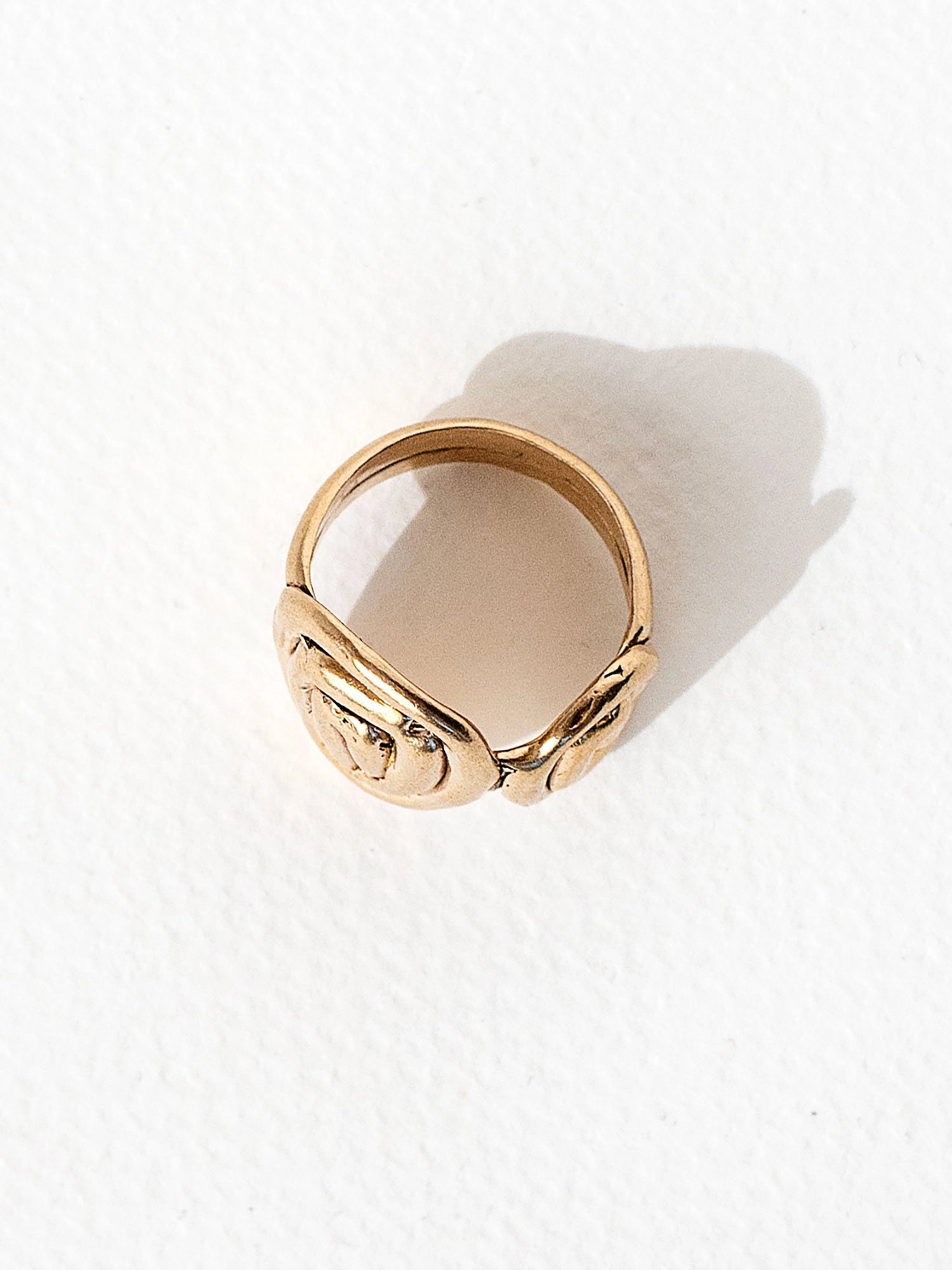 A hand formed brass ring with spiral geometric signet detail by Canadian jewelry designer Michelle Ross