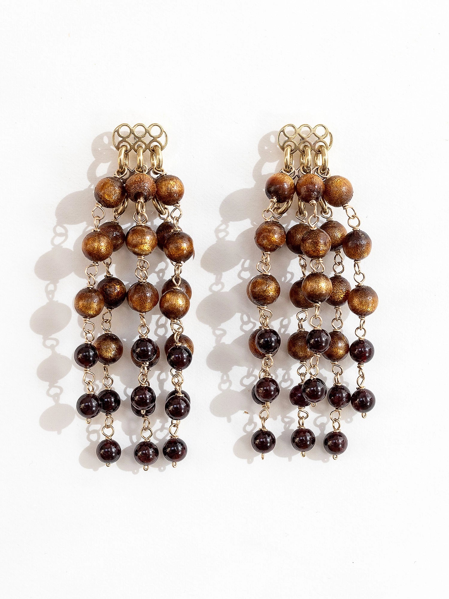 Pair of beaded dangly chandelier earrings made from sea bamboo and garnet beads by Michelle Ross