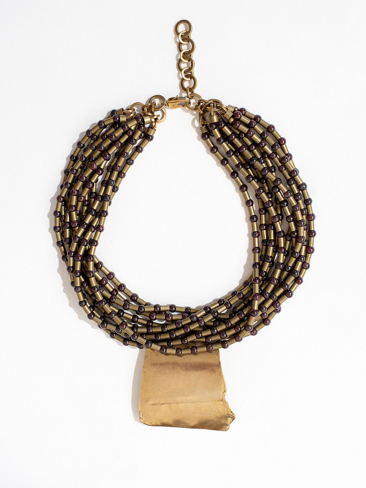 Multistrand beaded necklace with brass pendant