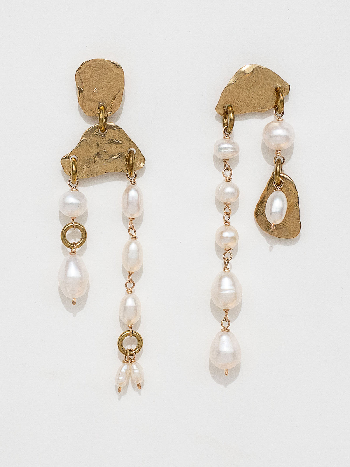 Pair of gold and pearl asymmetric chandelier earrings by Michelle Ross