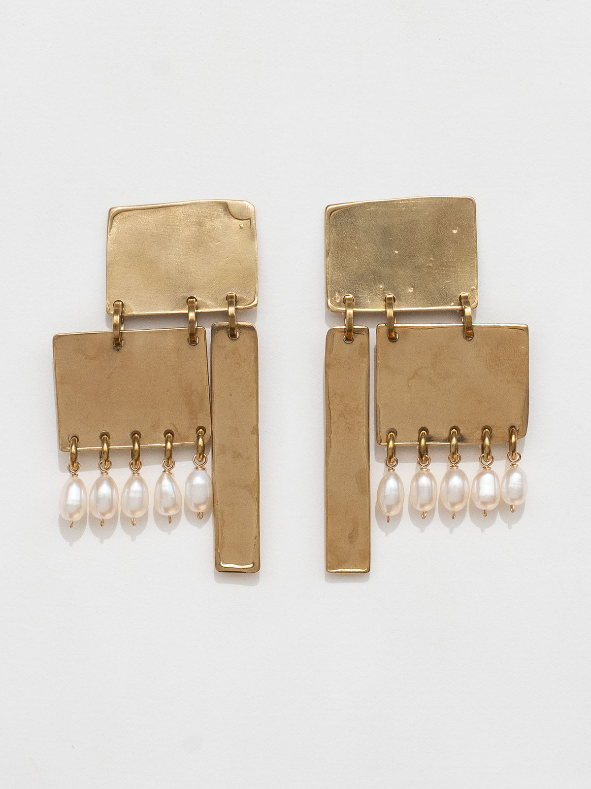 Gold coloured brass statement earrings with pearl drops by Michelle Ross