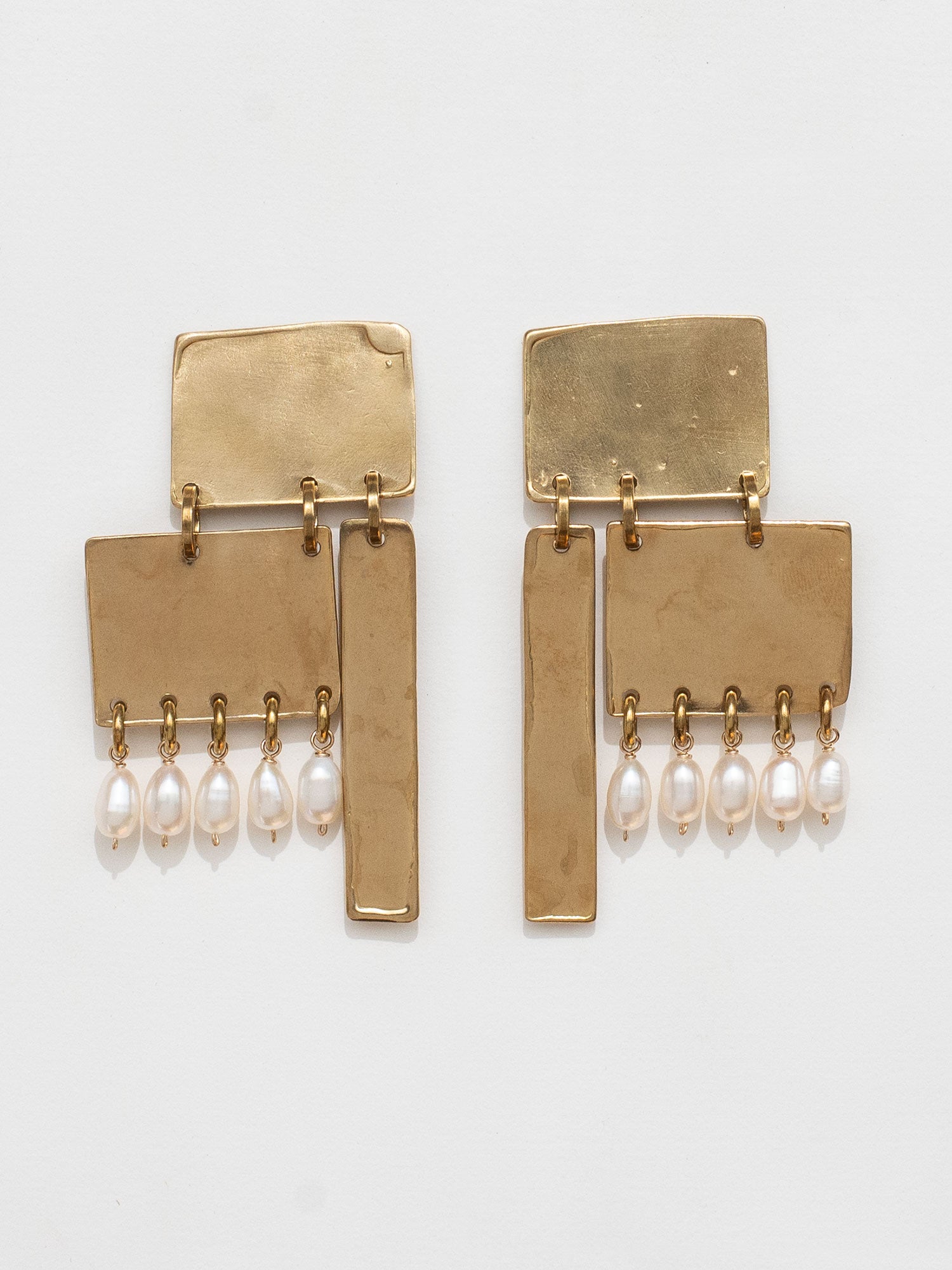 Gold coloured brass statement earrings with pearl drops by Michelle Ross