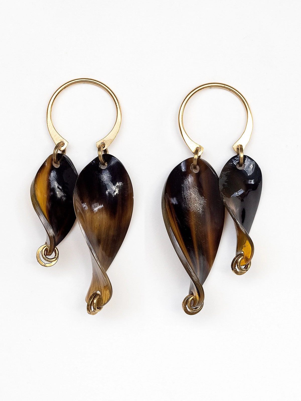 Pair of twisted horn earrings with brass details by Michelle Ross