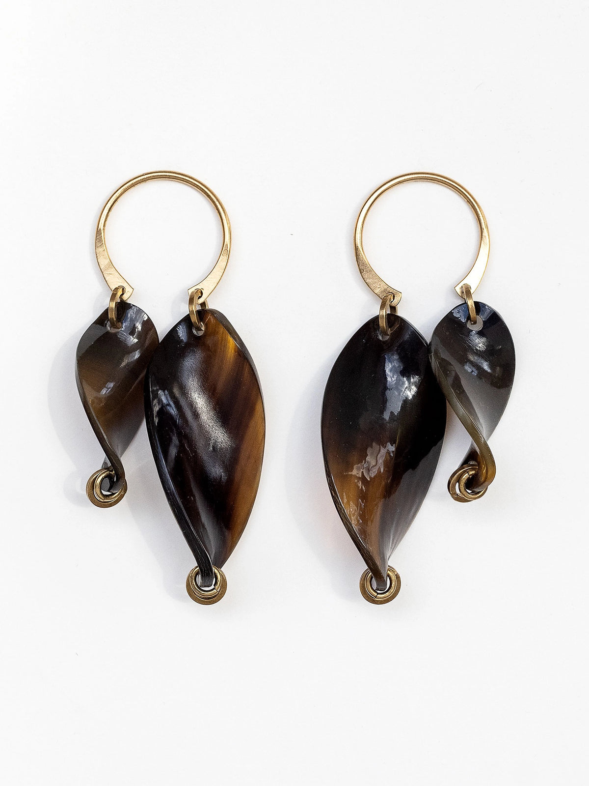 Pair of twisted horn earrings with brass details by Michelle Ross