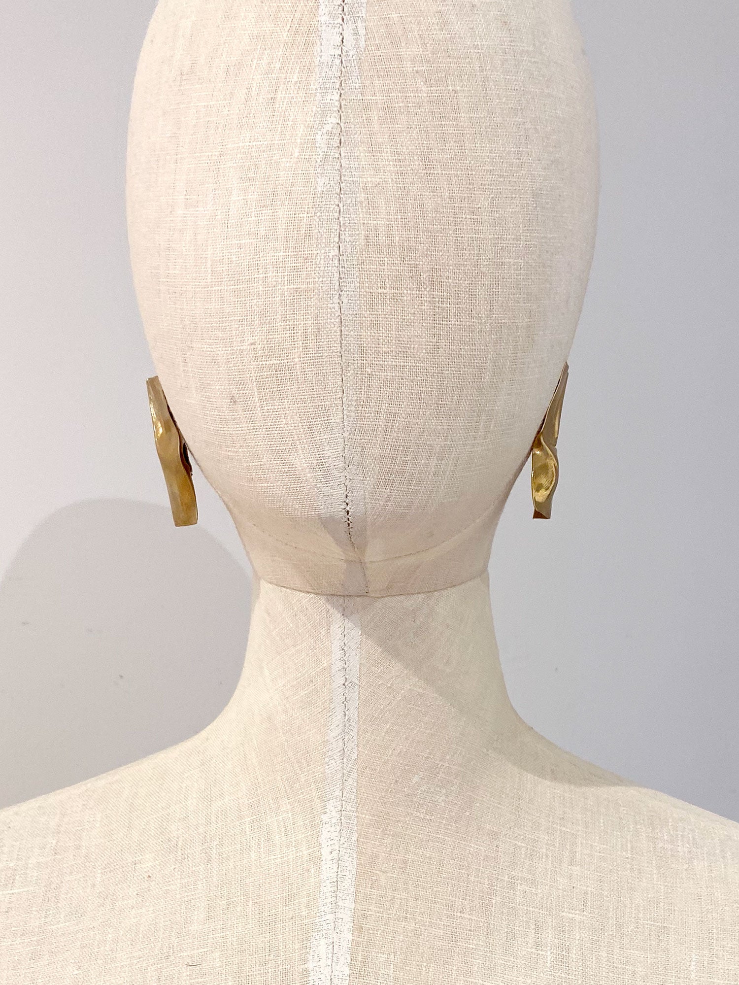 pair of gold brass statement stud earrings by Michelle Ross