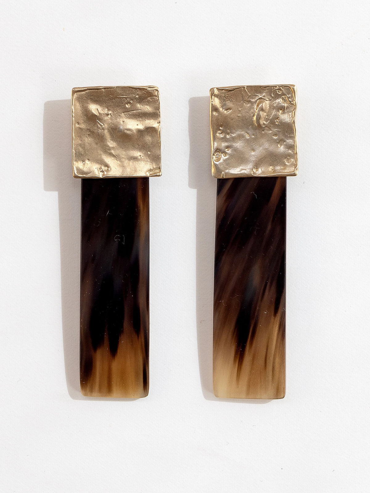 Pair of statement stud earrings with brass tops and brown horn 