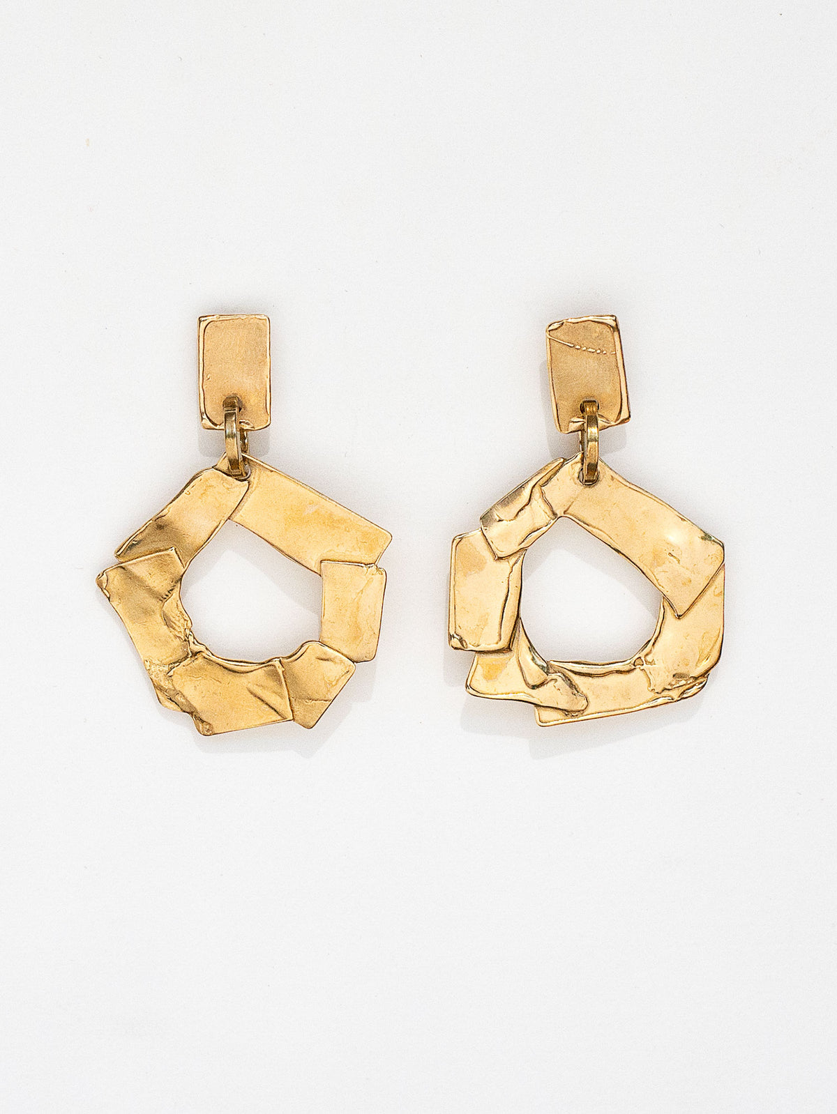 a pair of gold coloured brass earrings by Michelle Ross